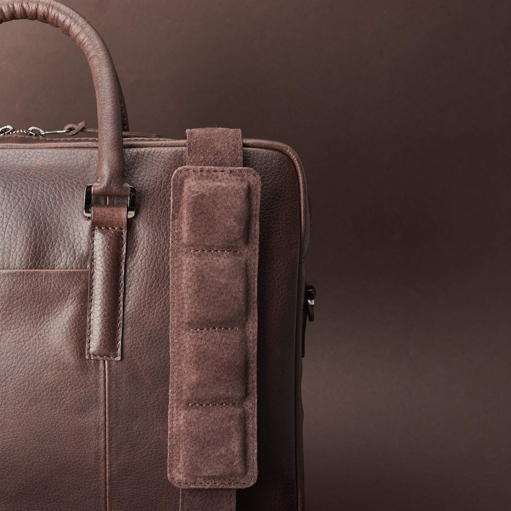 Detail of strap of shoulder bag. Dark Brown leather briefcase laptop bag for men. Gazeli laptop briefcase by Capra Leather.