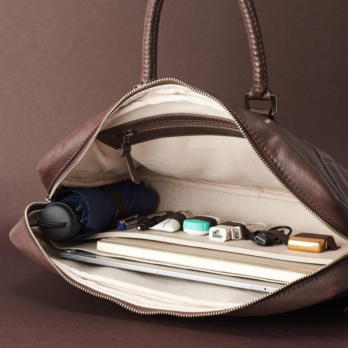 Interior in use .Dark Brown leather briefcase laptop bag for men. Gazeli laptop briefcase by Capra Leather.