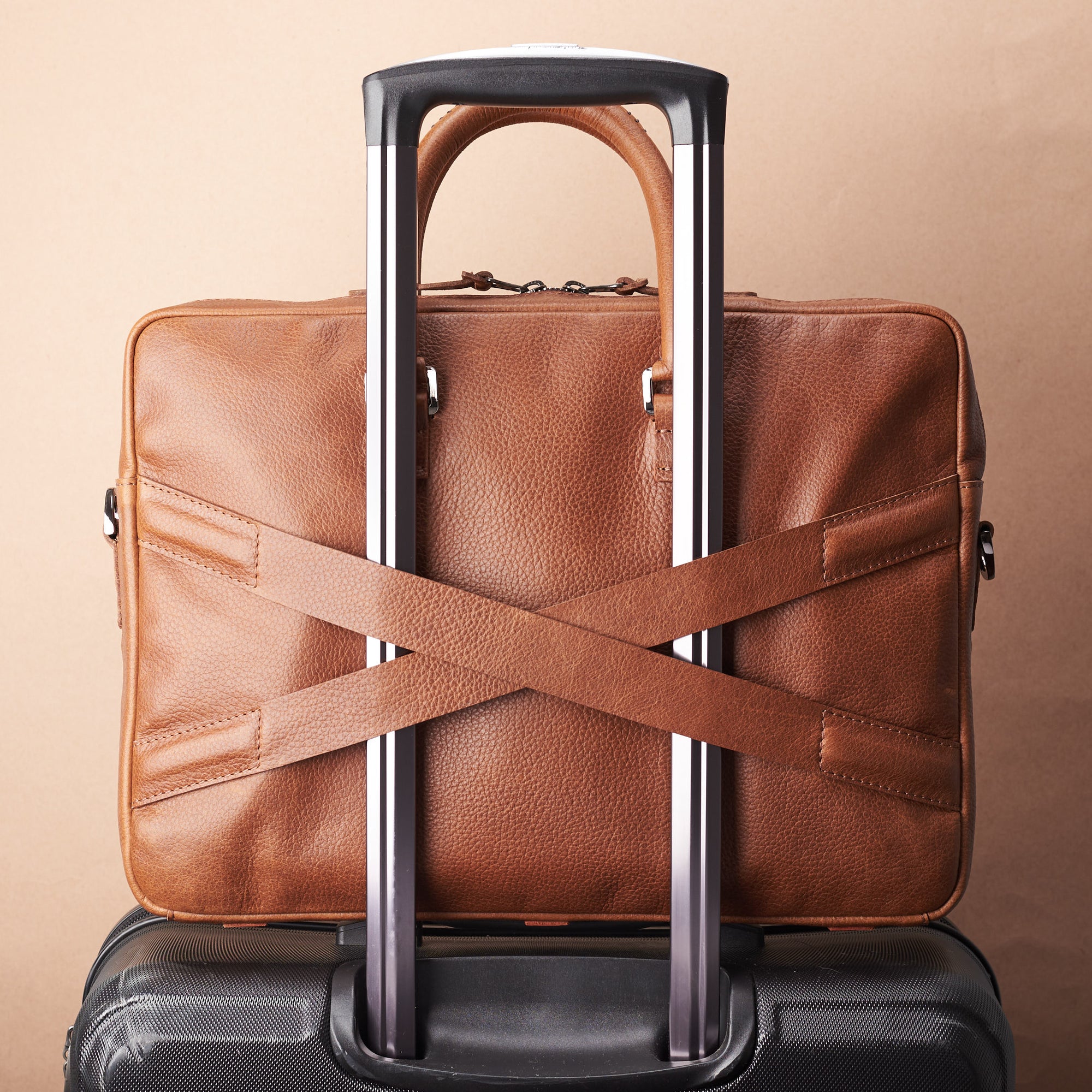 Luggage strap in x shape for messenger bag. Tan leather briefcase laptop bag for men. Gazeli laptop briefcase by Capra Leather.