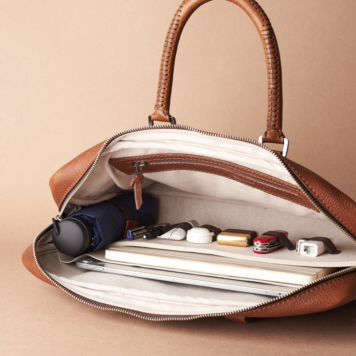 Interior in use . Tan leather briefcase laptop bag for men. Gazeli laptop briefcase by Capra Leather.