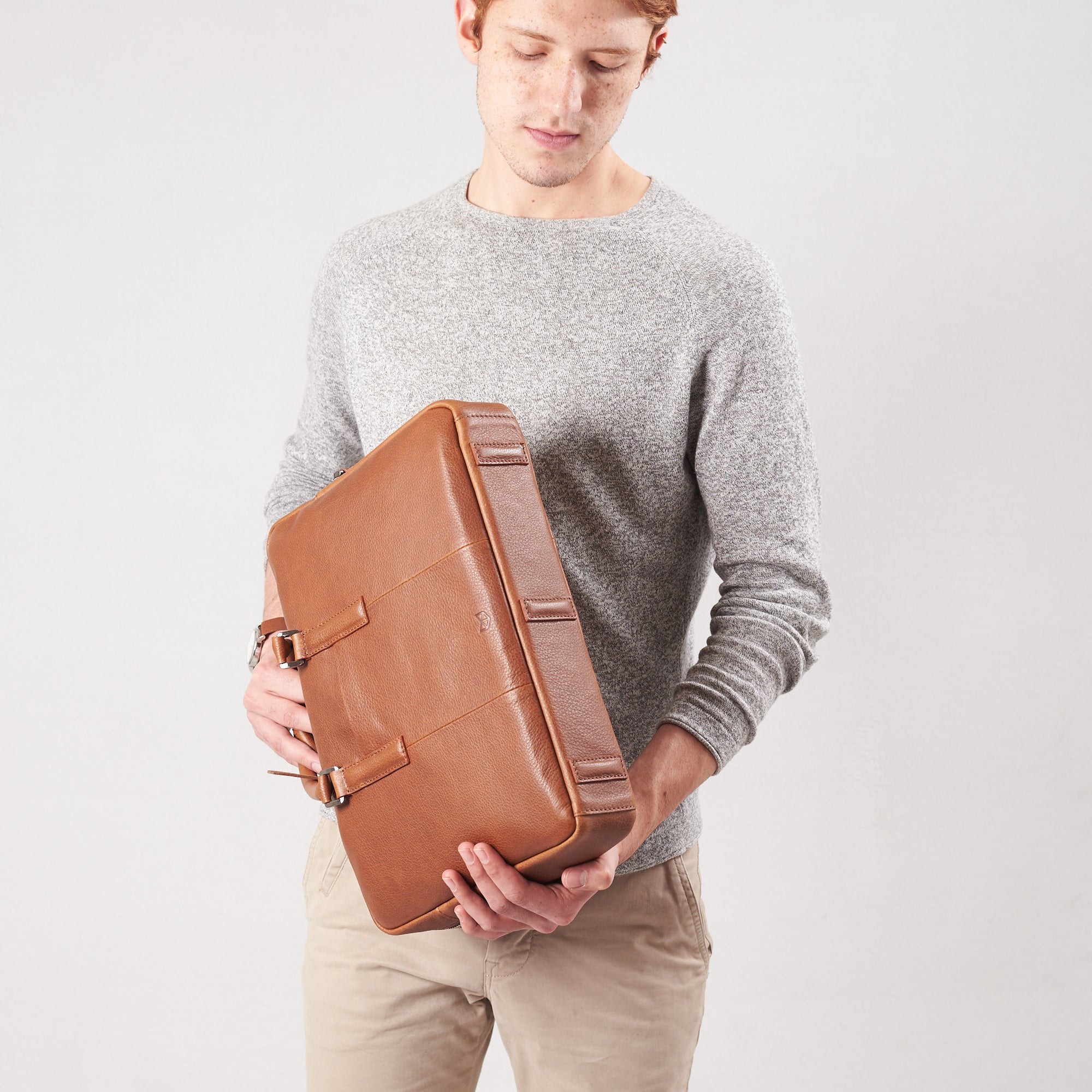 Style detail bag bottom feet hold. Tan leather briefcase laptop bag for men. Gazeli laptop briefcase by Capra Leather.