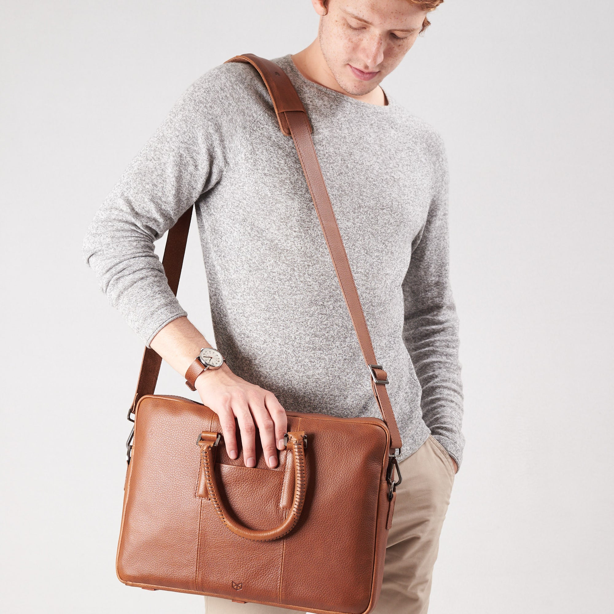 Shoulder bag in use by model. Tan leather briefcase laptop bag for men. Gazeli laptop briefcase by Capra Leather