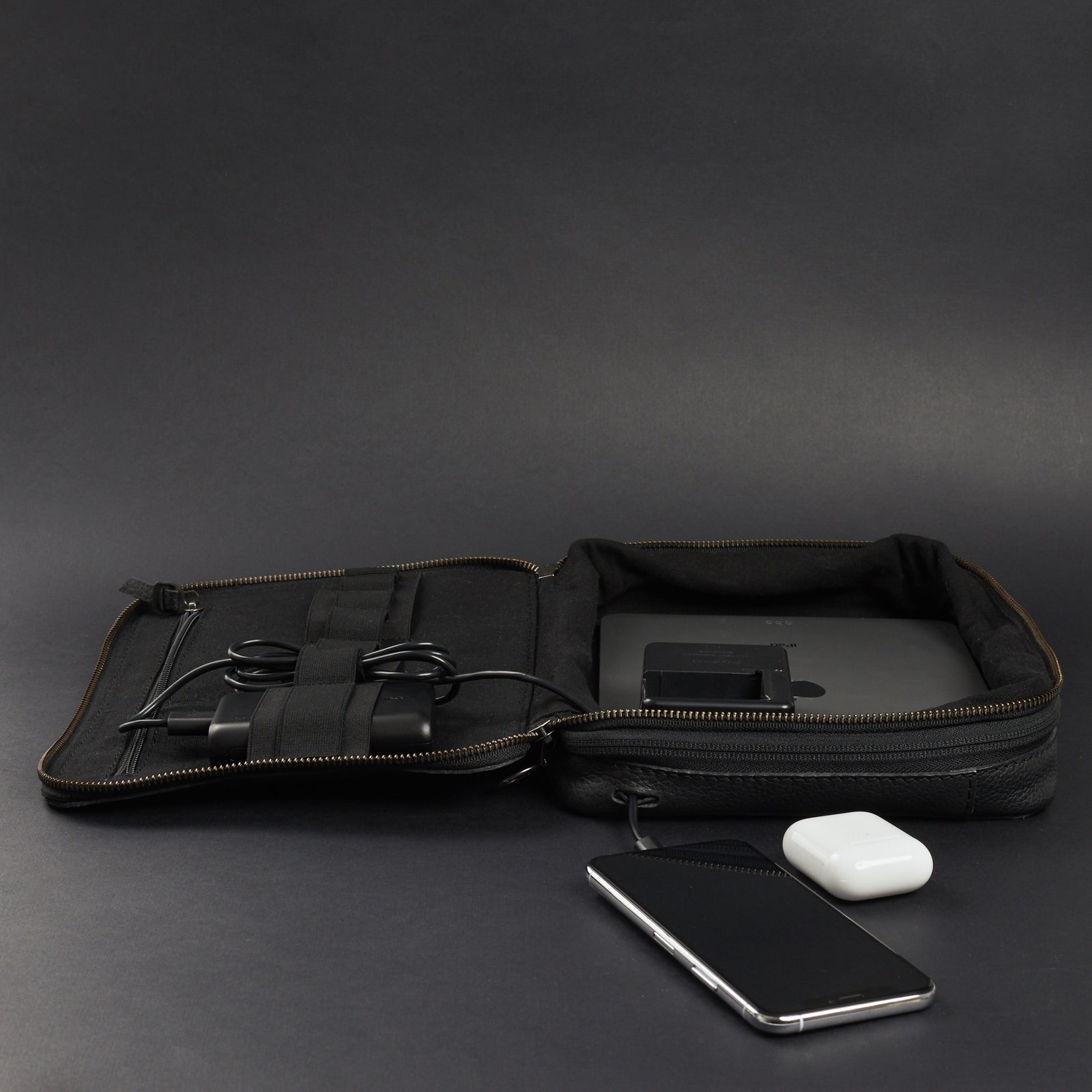 Cable passthrough. Black leather gear bag by Capra