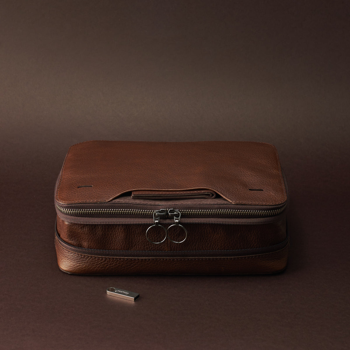 Expansion and compression system. Brown tech gear zipper bagby Capra Leather