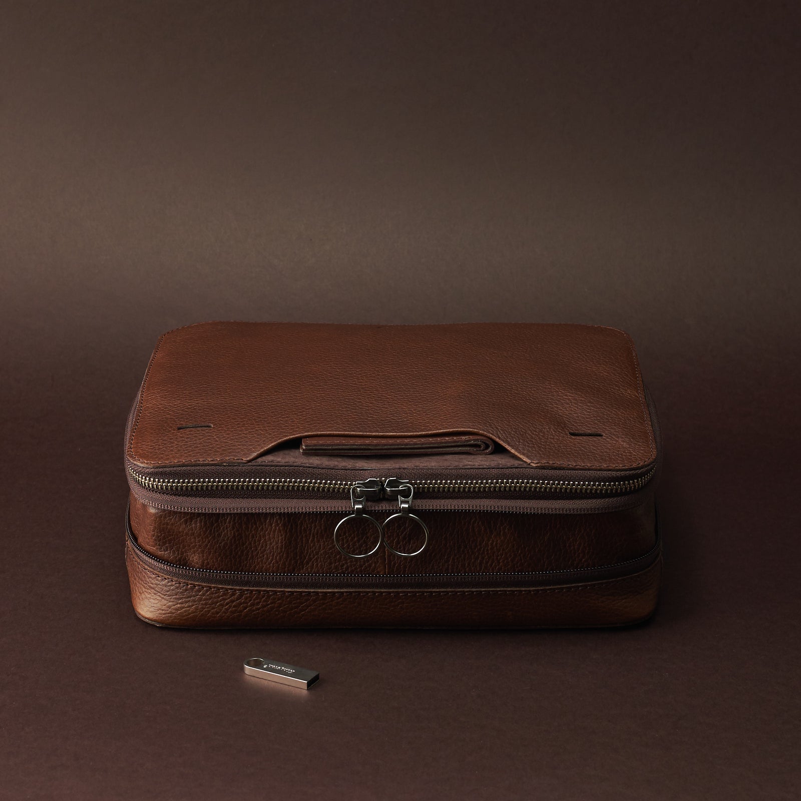 Expansion and compression system. Brown tech gear zipper bagby Capra Leather