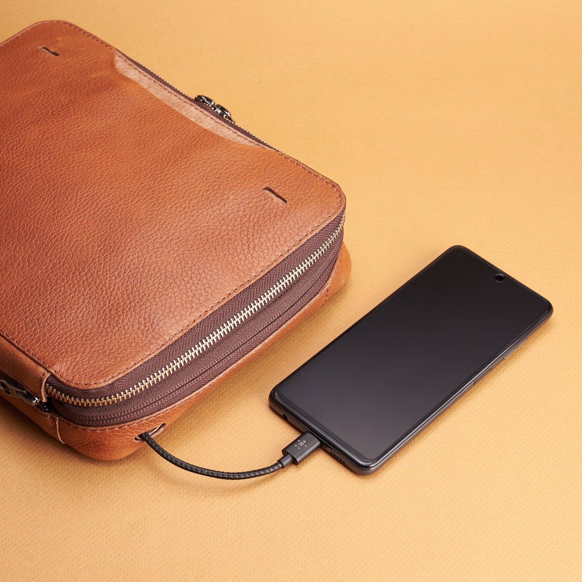 Cable hole. Tan small gadget organizer by Capra Leather