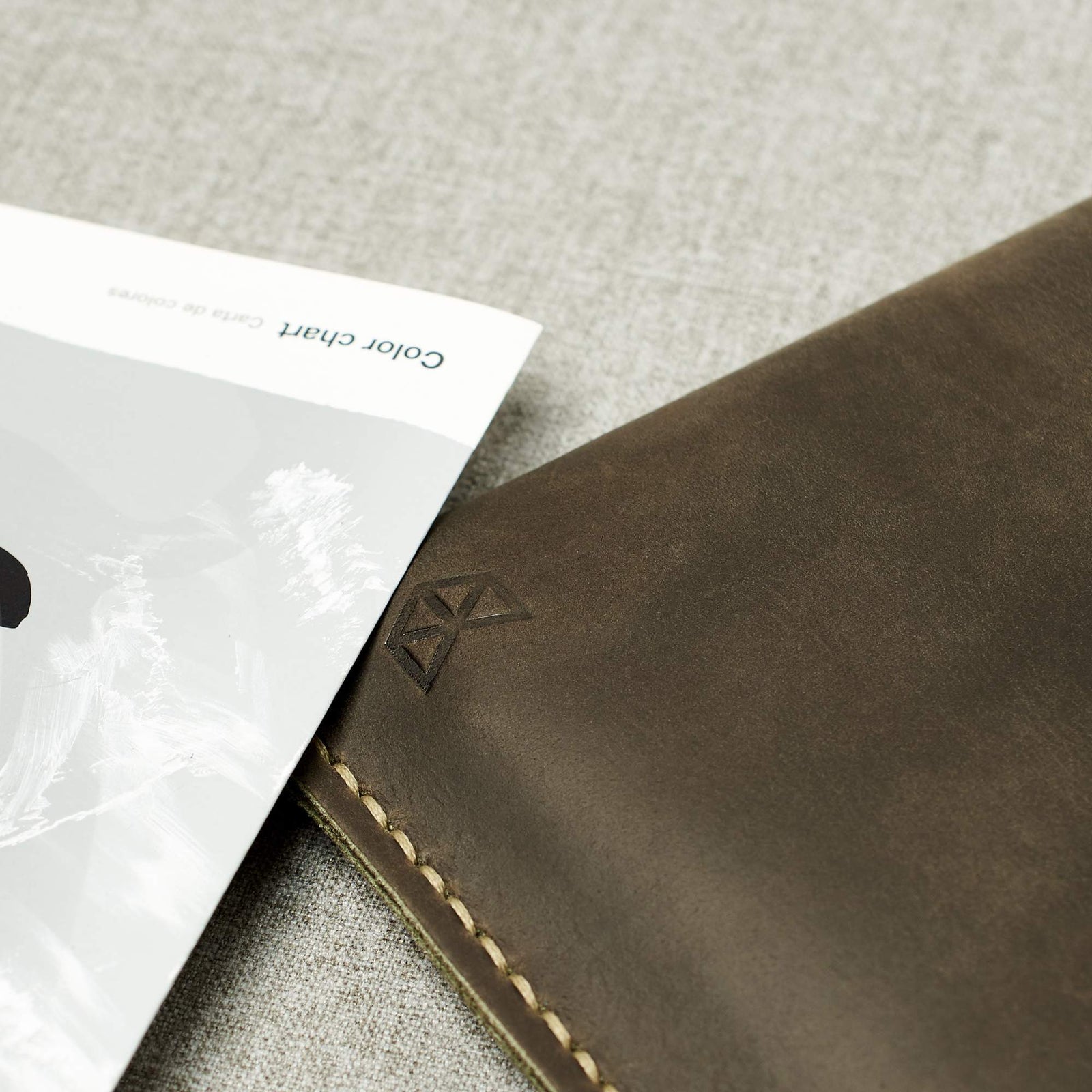 Detail. Green Google Pixelbook leather sleeve with Google pen holder.