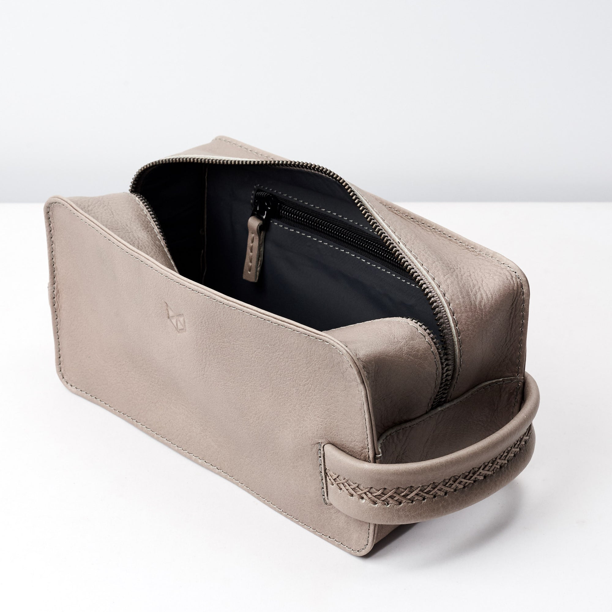 Leather toiletry bag with interior pocket for small essentials. Grey leather shaving bag for mens gifts