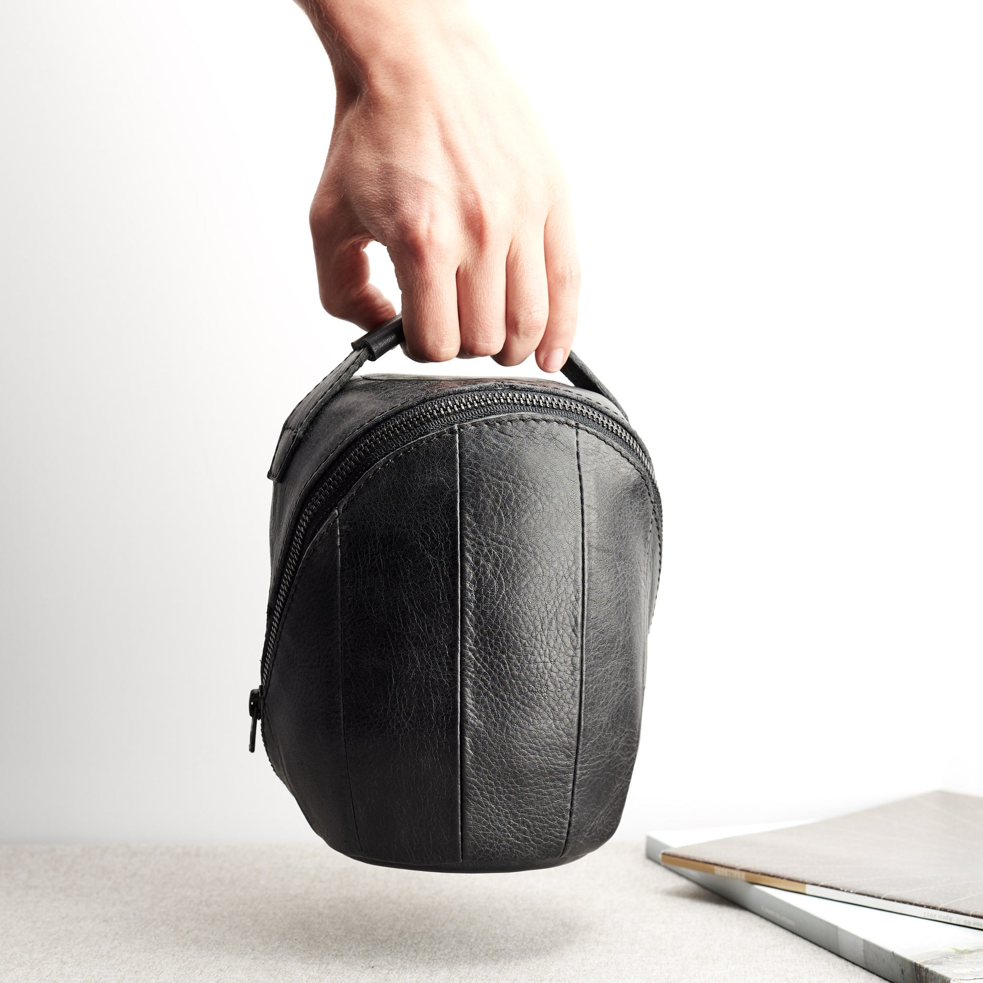 Carrying the HomePod. HomePod black leather travel carrying case.