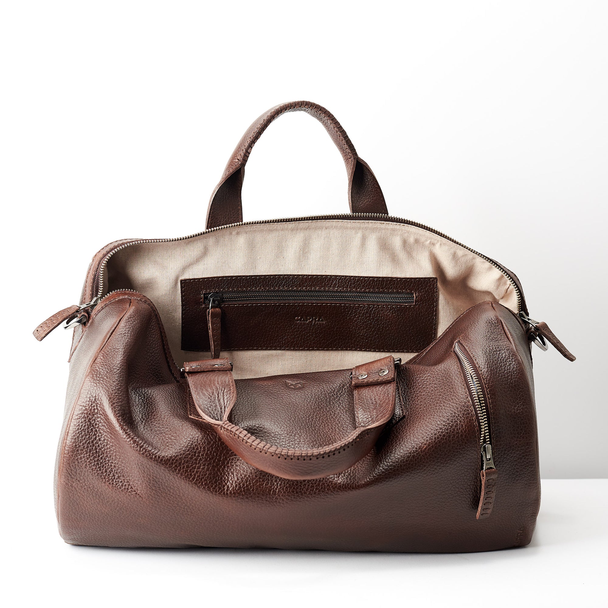 Linen interior. Dark brown leather handbag duffle bag for men