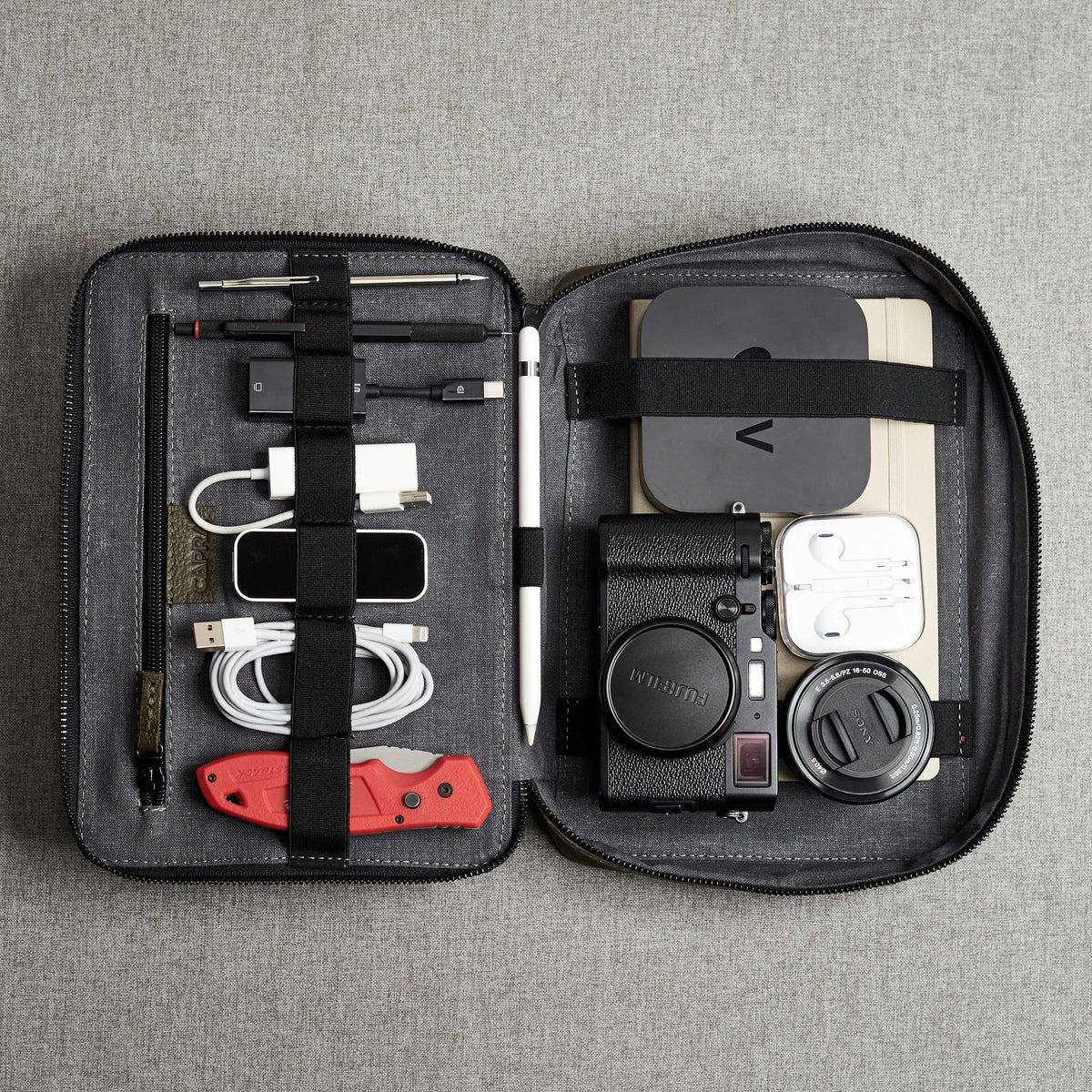 Travel essentials. Green EDC gear bag by Capra Leather. Fits iPad 11 Pro
