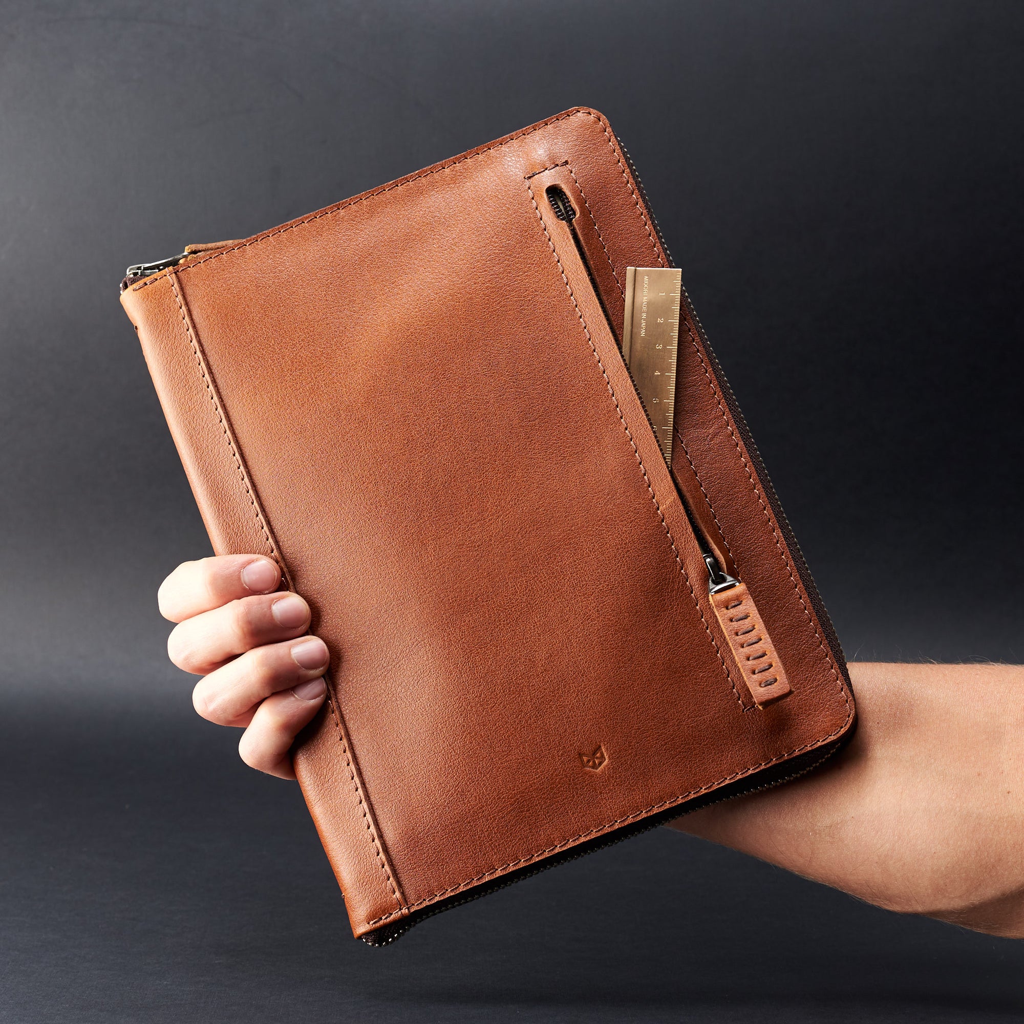 Holding hand. A5 leather notebook cover by Capra Leather. Gifts for artists.