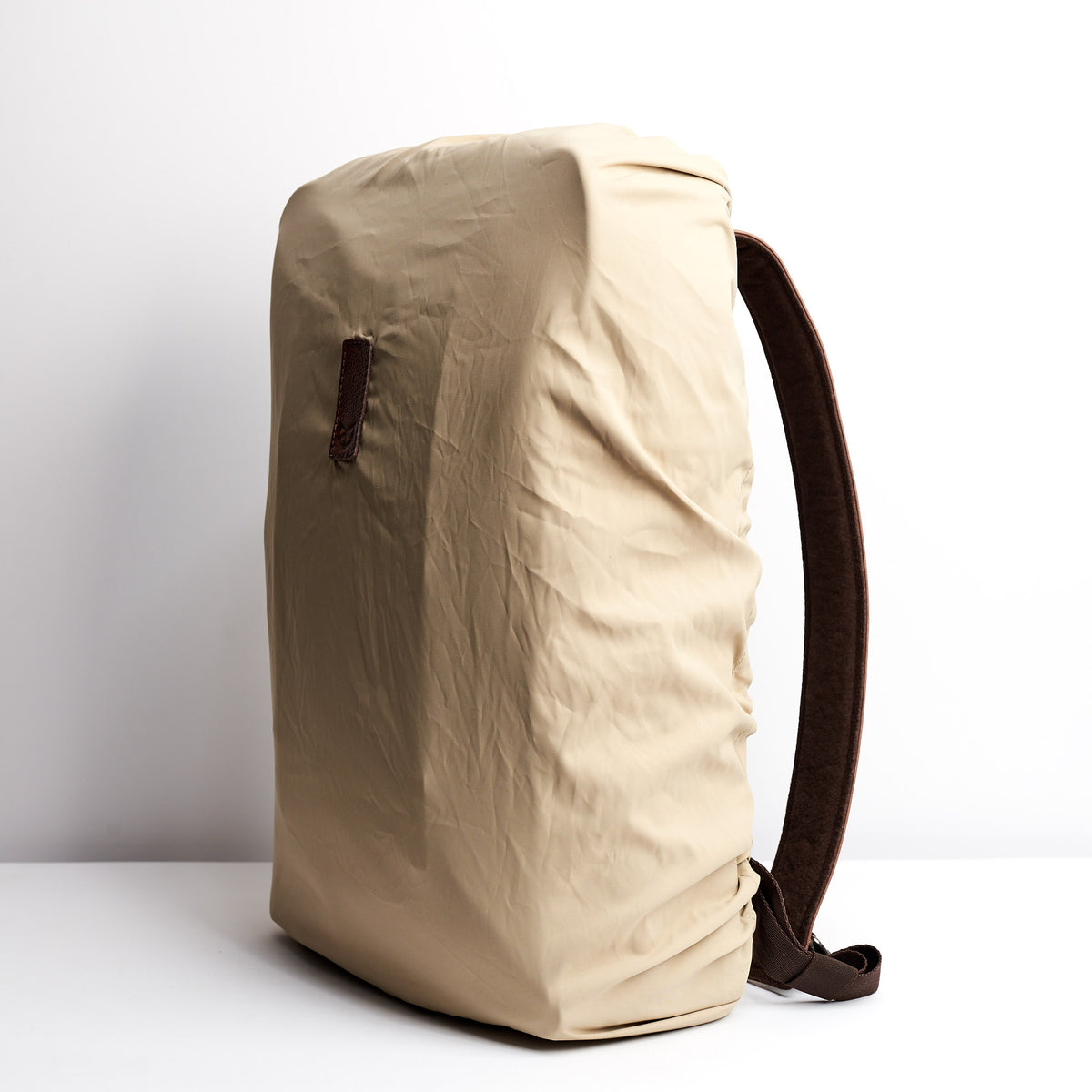 Angle Beige Perfect fit for all Capra backpacks. Fashionable matte waterproof material. Leather details by Capra Leather.
