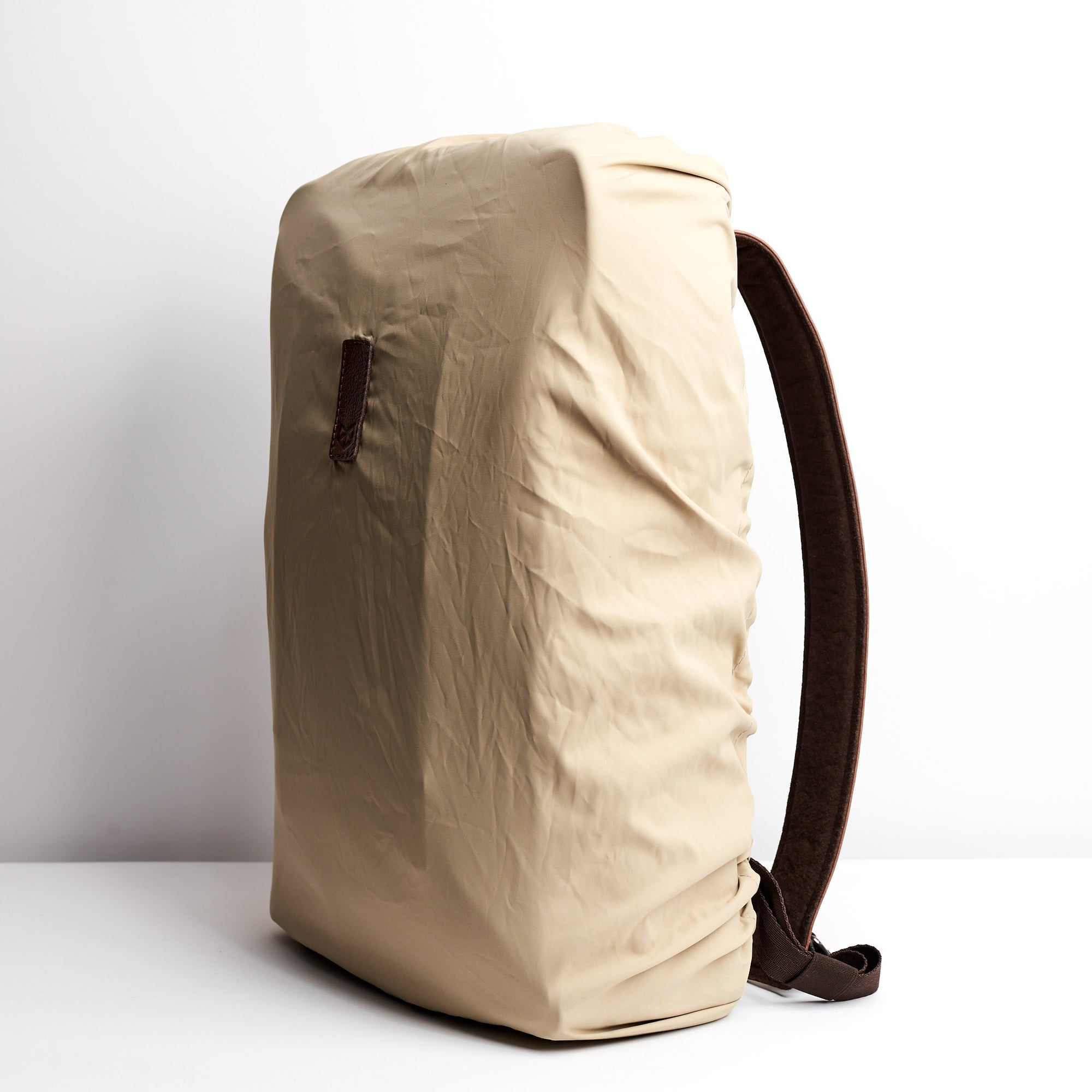 Front Beige Perfect fit for all Capra backpacks. Fashionable matte waterproof material. Leather details by Capra Leather.
