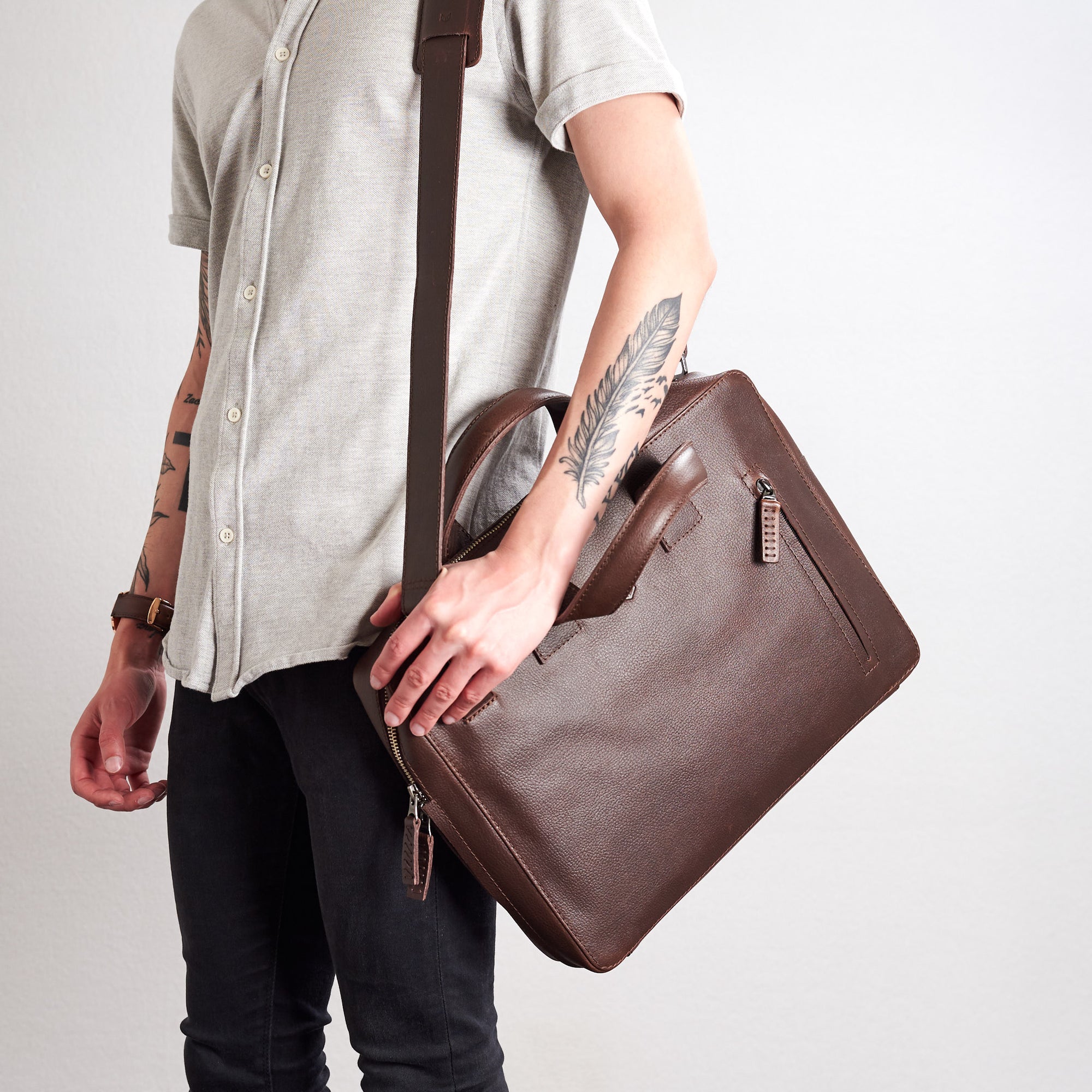 Roko briefcase in color dark brown. Style front picture with shoulder strap in use.