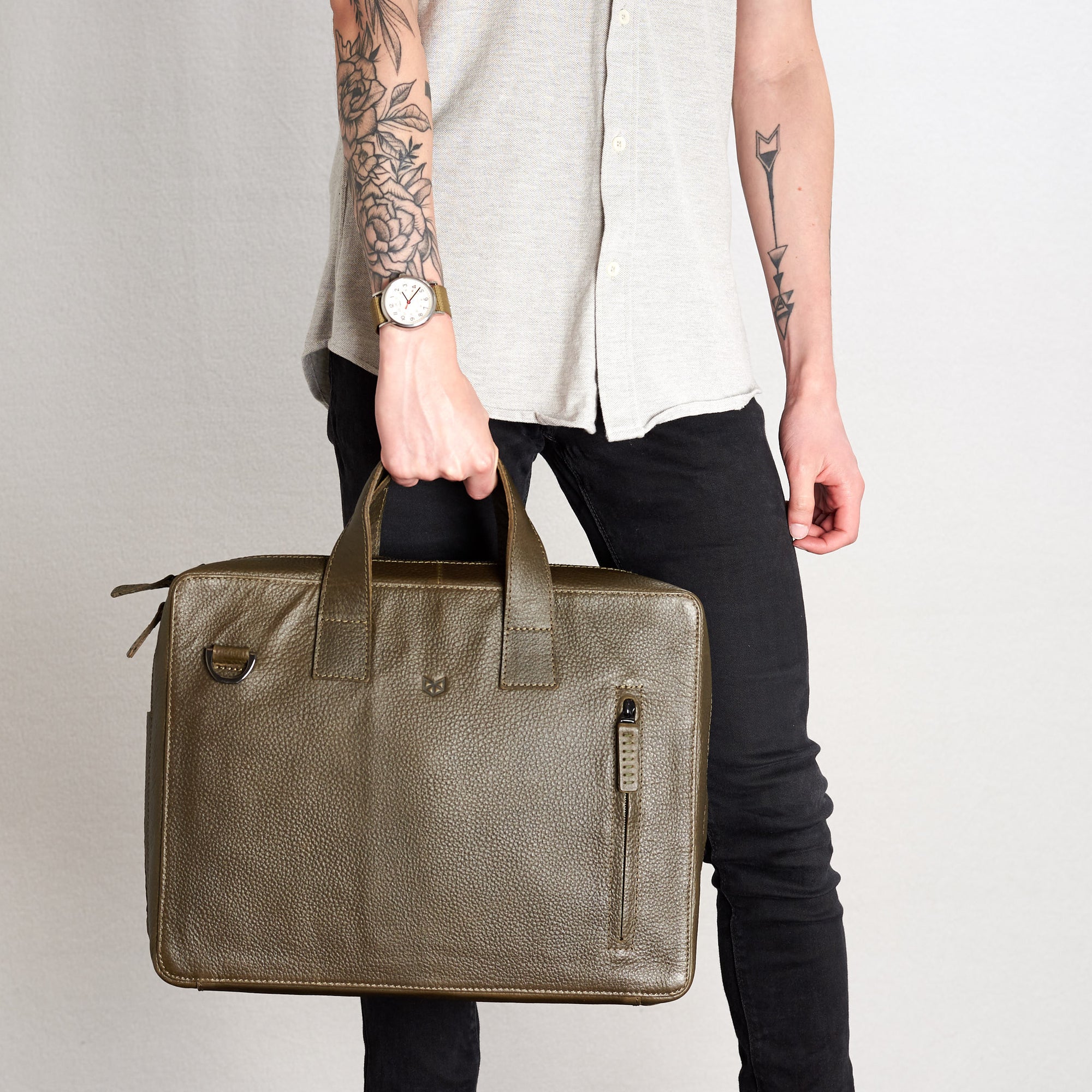 Style front picture handles holding Roko green briefcase.