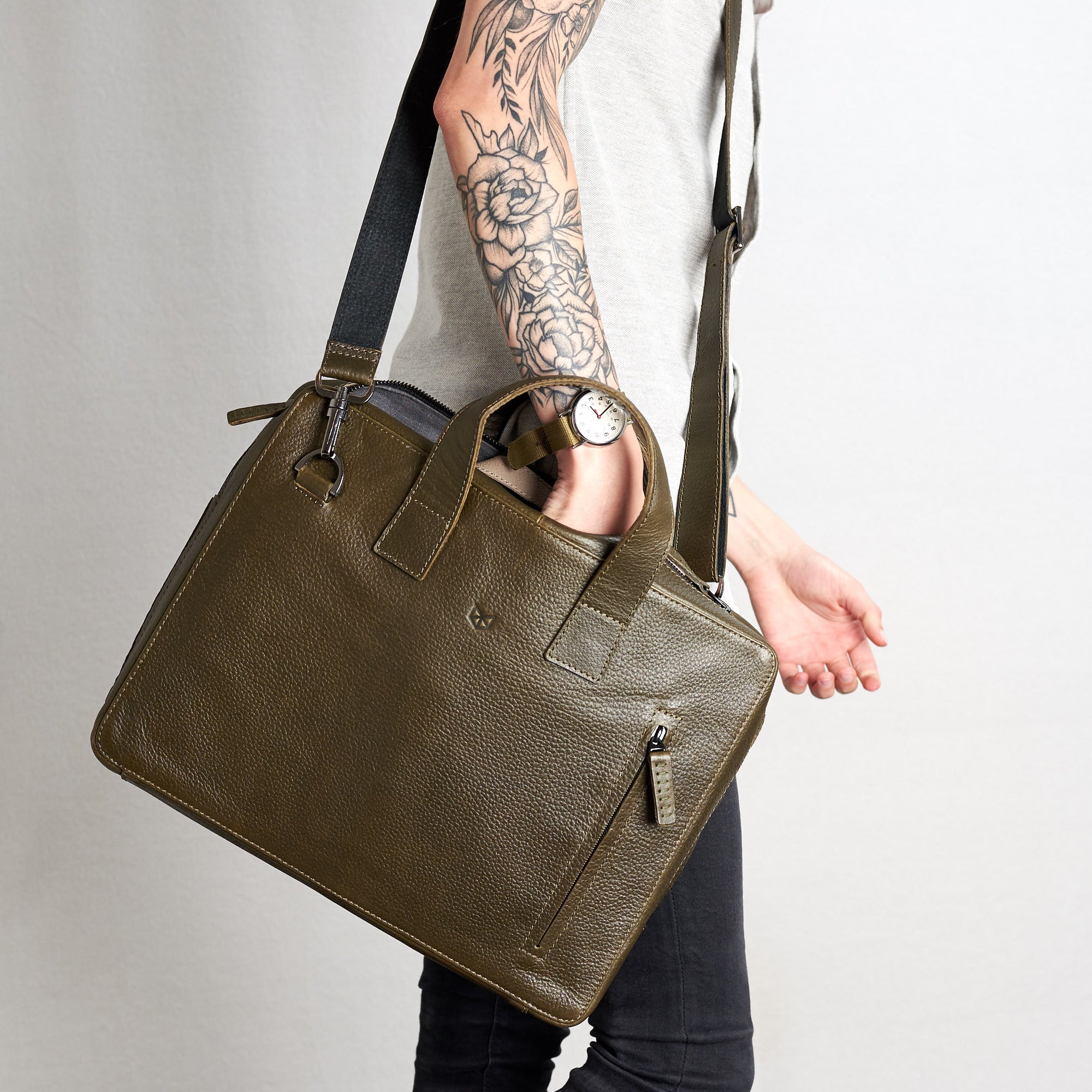 Style hand inside briefcase. Roko green by Capra Leather.