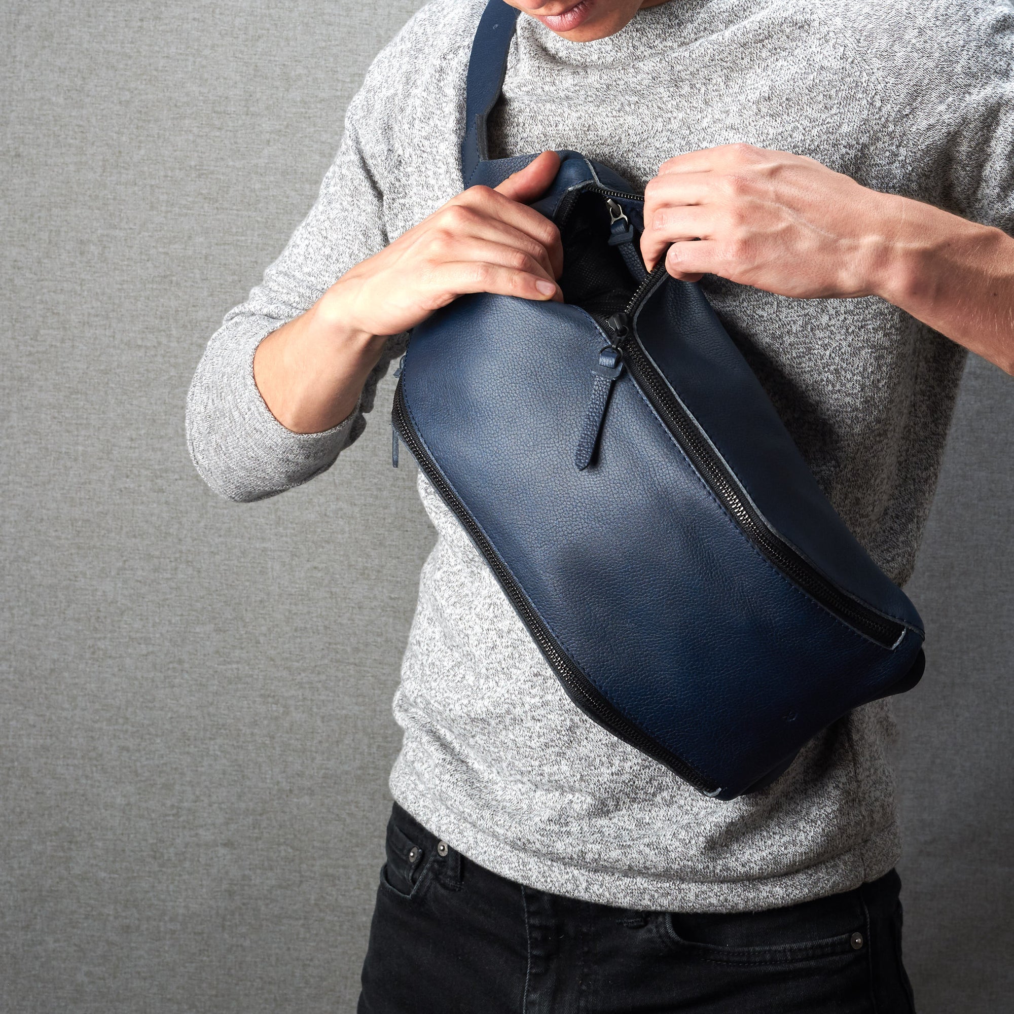Styling front. Fenek blue sling bag for men by Capra Leather. Urban over the shoulder bag.