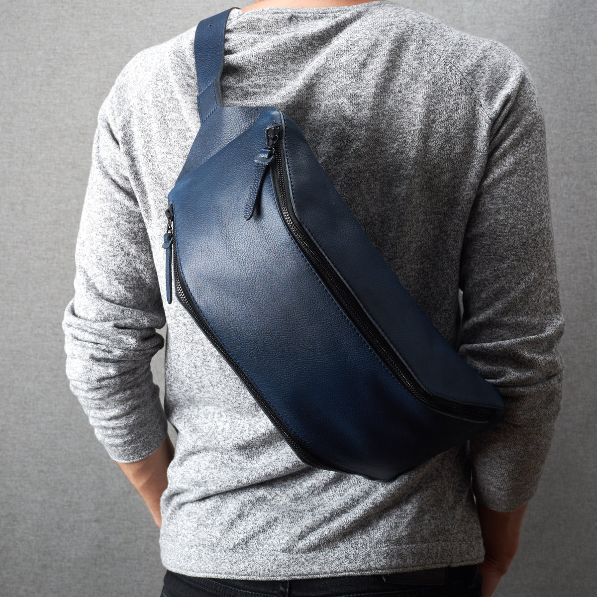 Styling side. Fenek blue sling bag for men by Capra Leather. Festival bag hip bag.