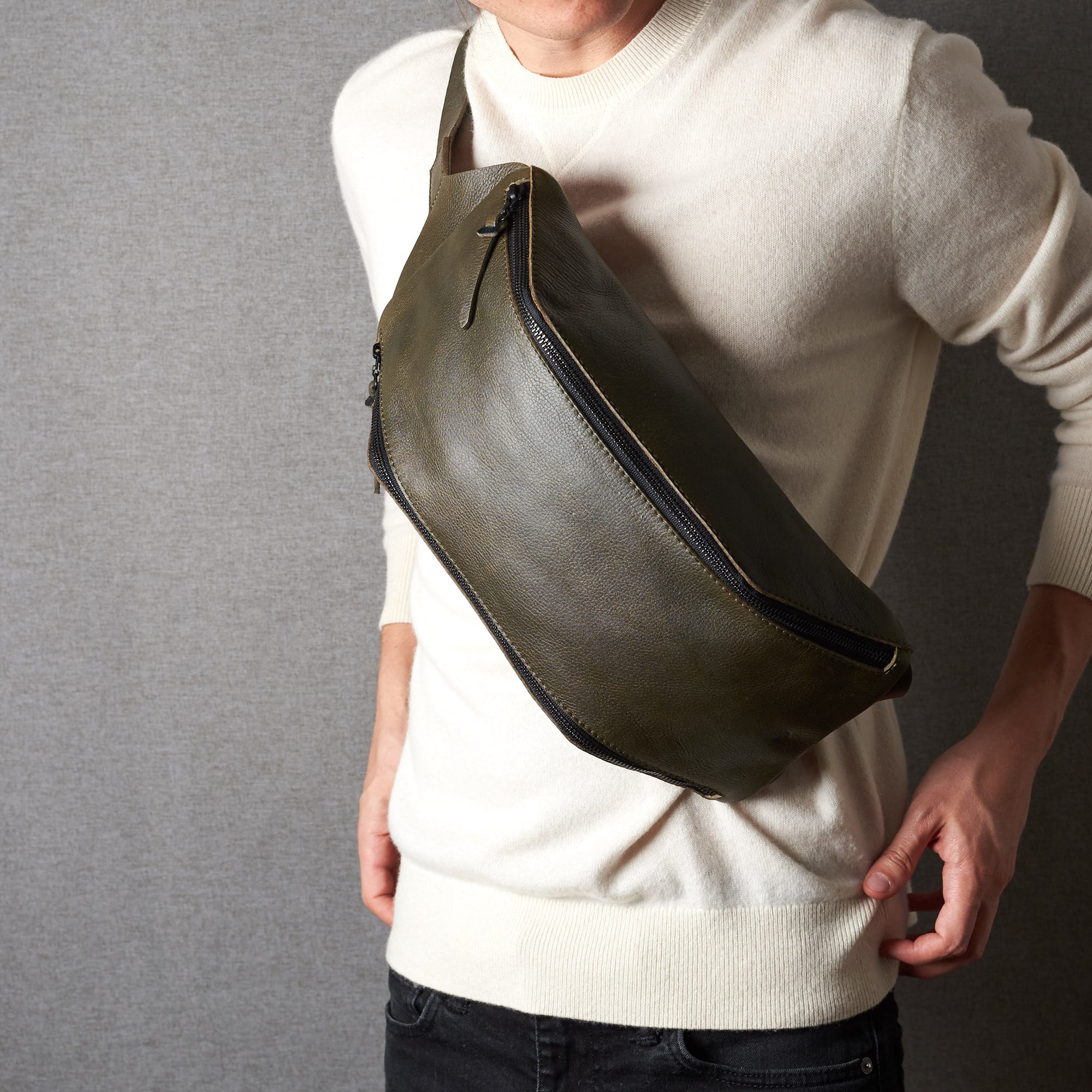 Styling front. Fenek green sling bag for men by Capra Leather. Urban hip bag over the shoulder.
