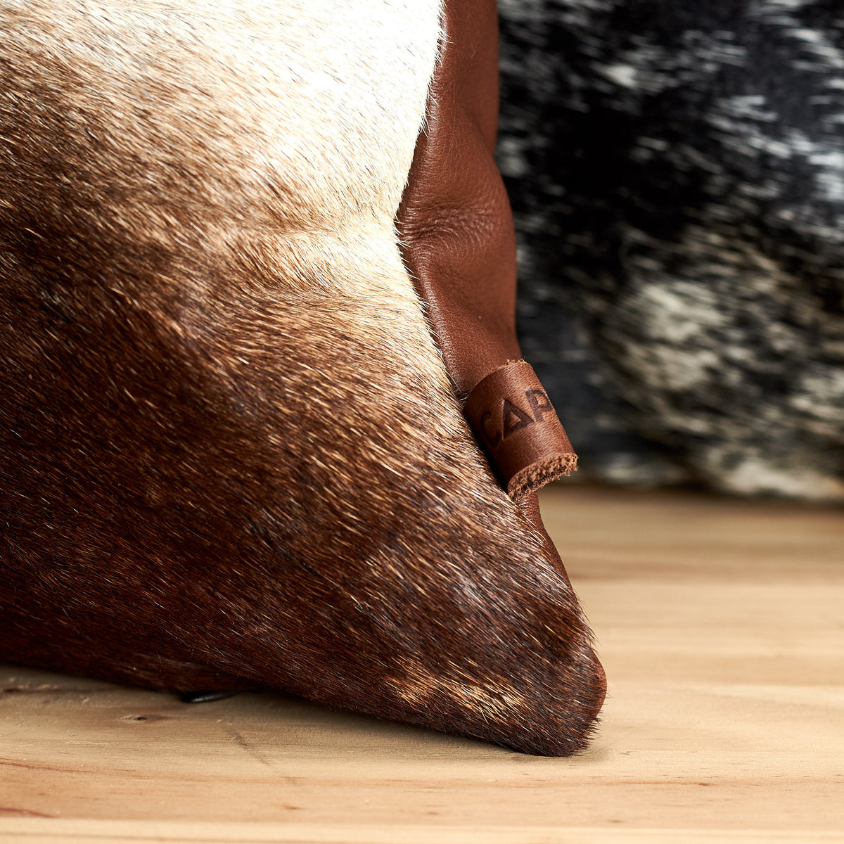 Capra Leather detail on cowhide cushion 
