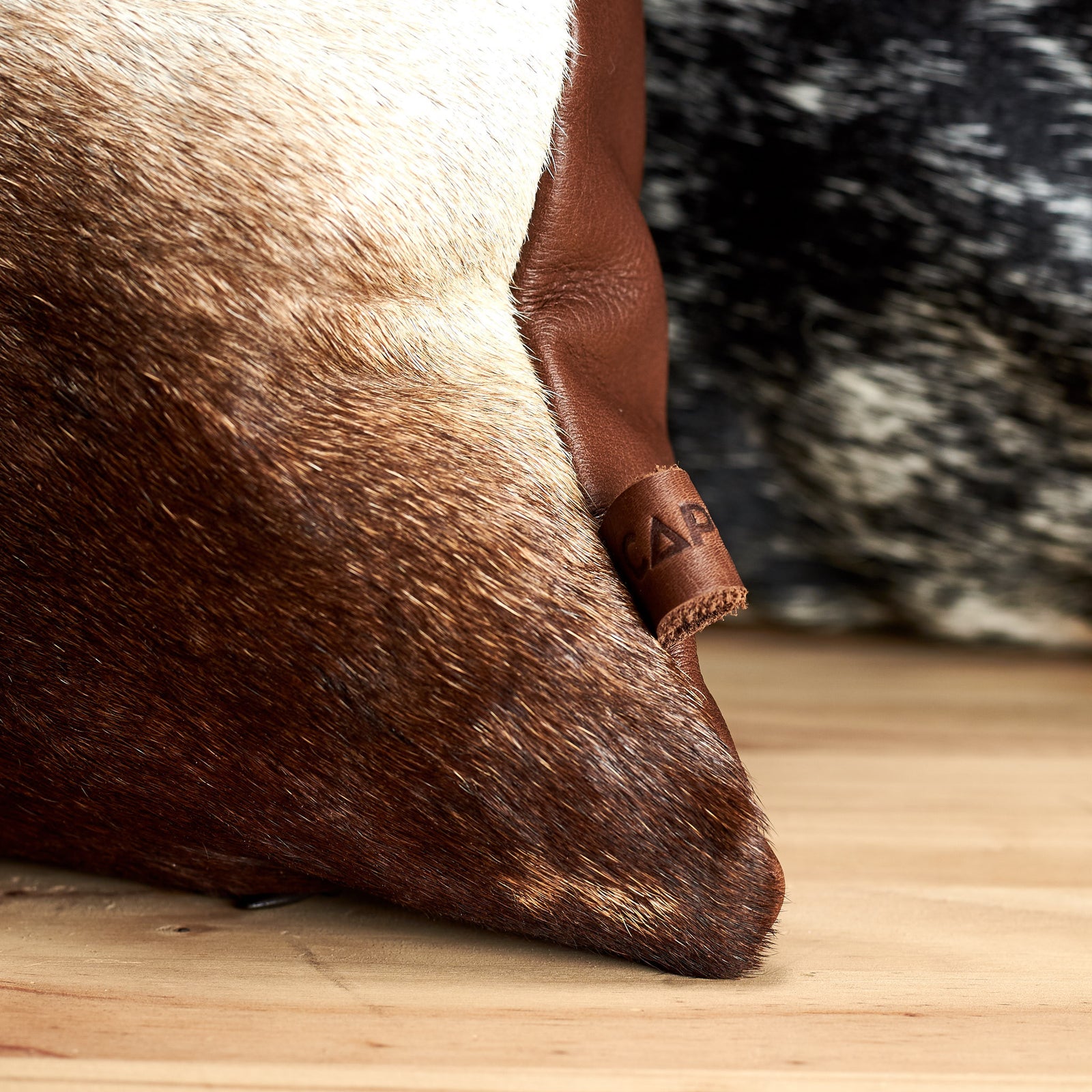 Capra Leather detail on cowhide cushion 
