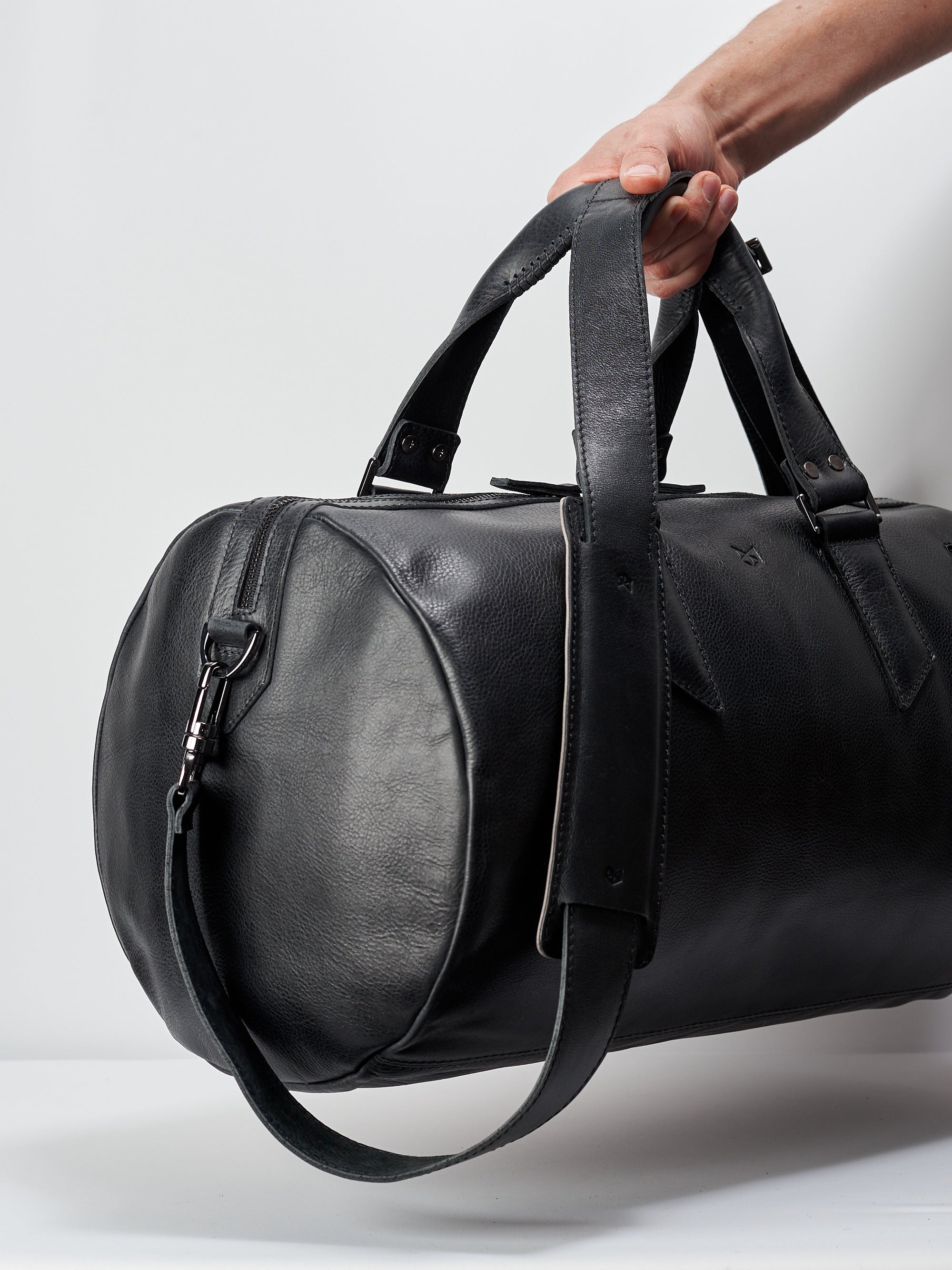 Style outside photo. Black leather duffle handbag for men. Travel designer bag 