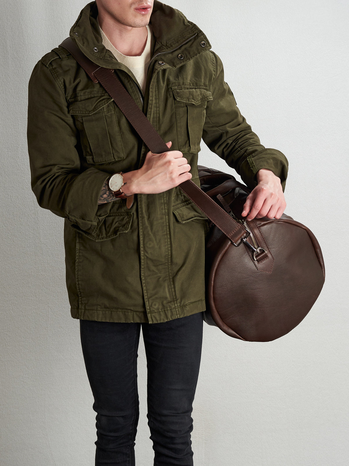 Shoulder strap with duffle bag on. Substantial dark brown duffle bag by Capra Leather.