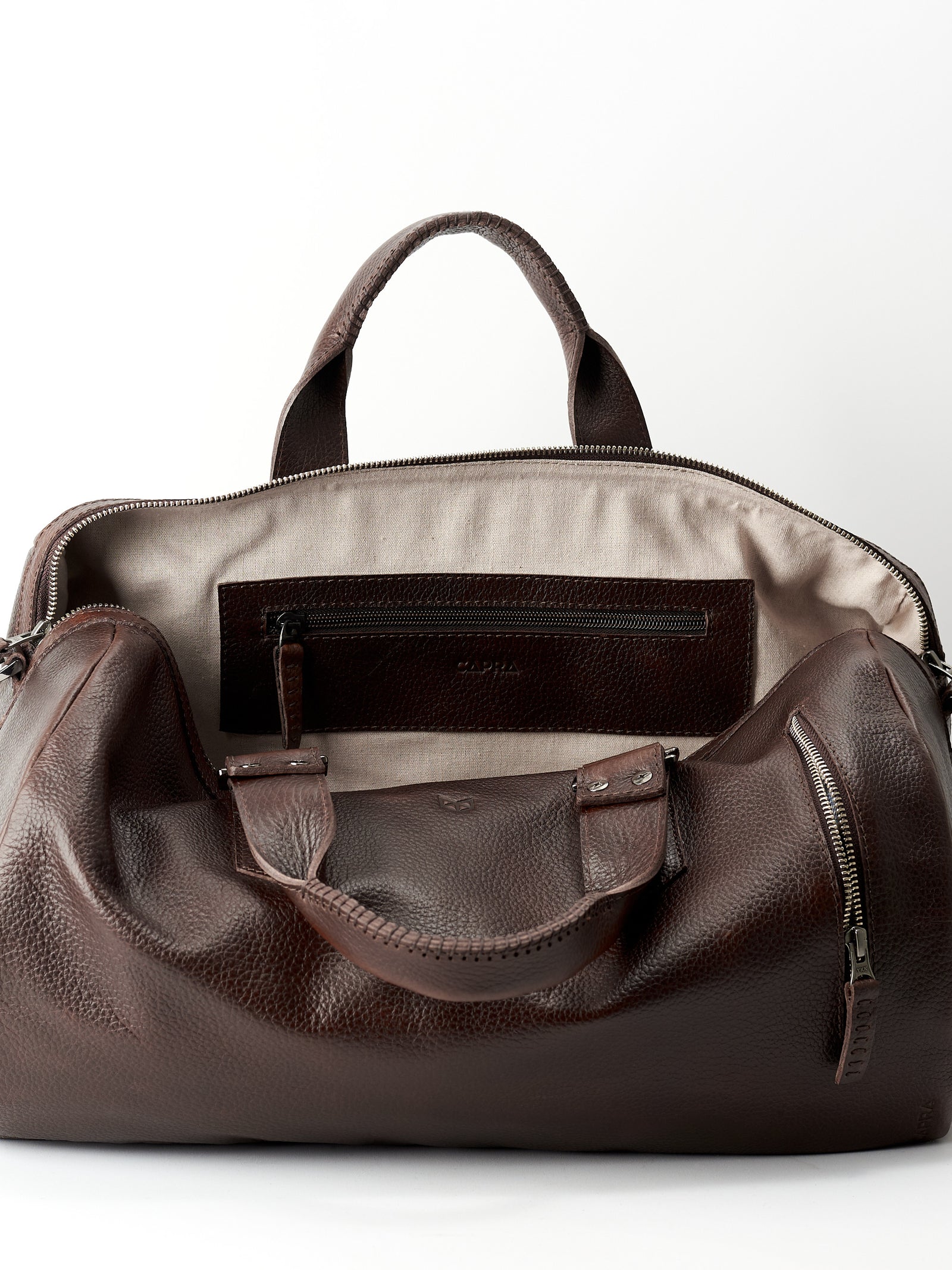 Linen interior. Dark brown leather handbag duffle bag for men