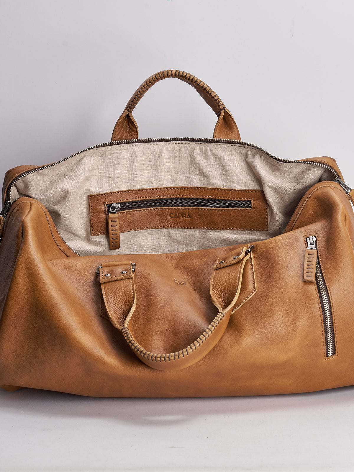 Linen interior. Handmade Tan brown leather duffle bag for men. Mens designer shoulder bag