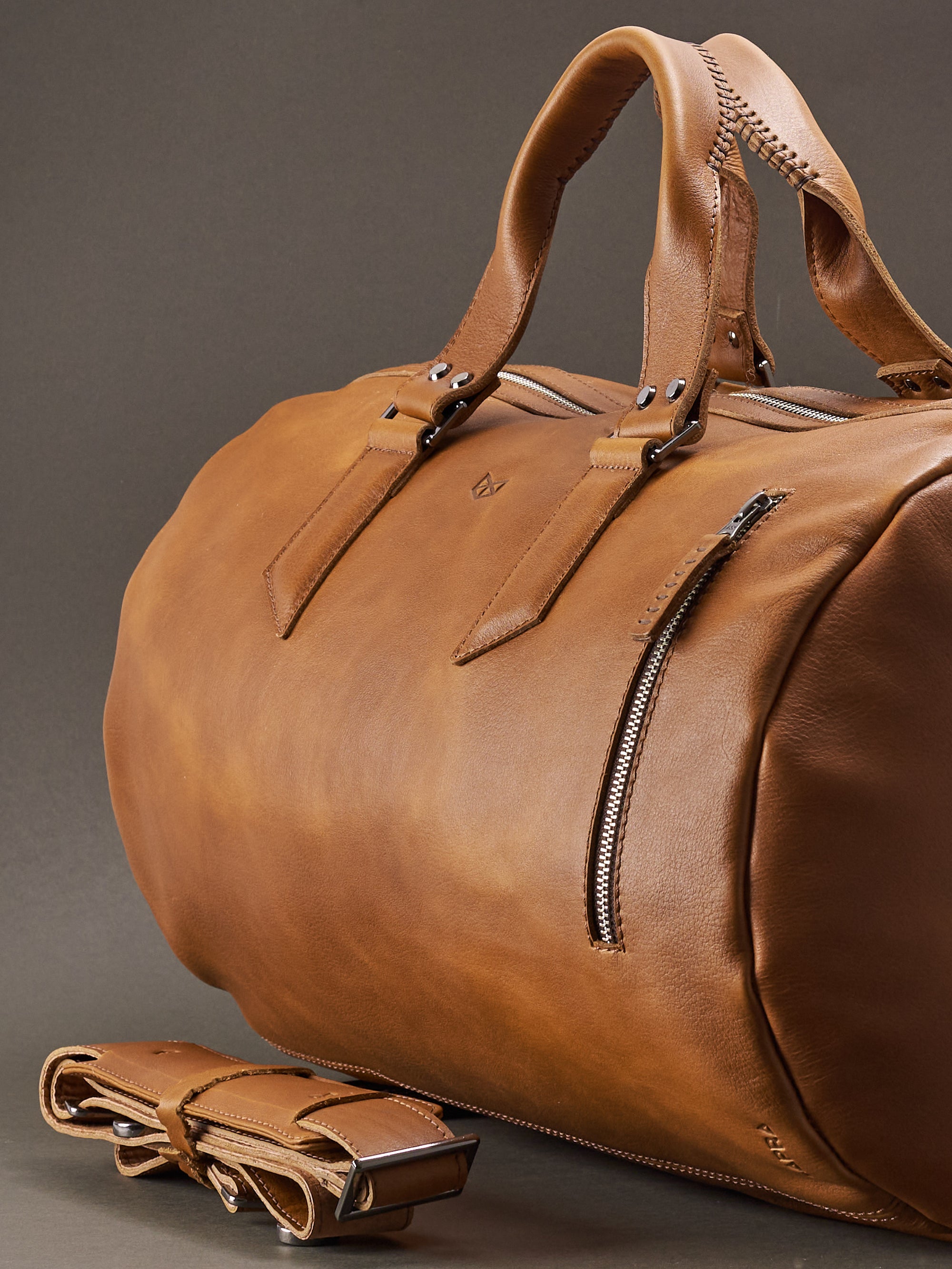 Substantial duffle bag tan by Capra Leather. Style semi side carry. 