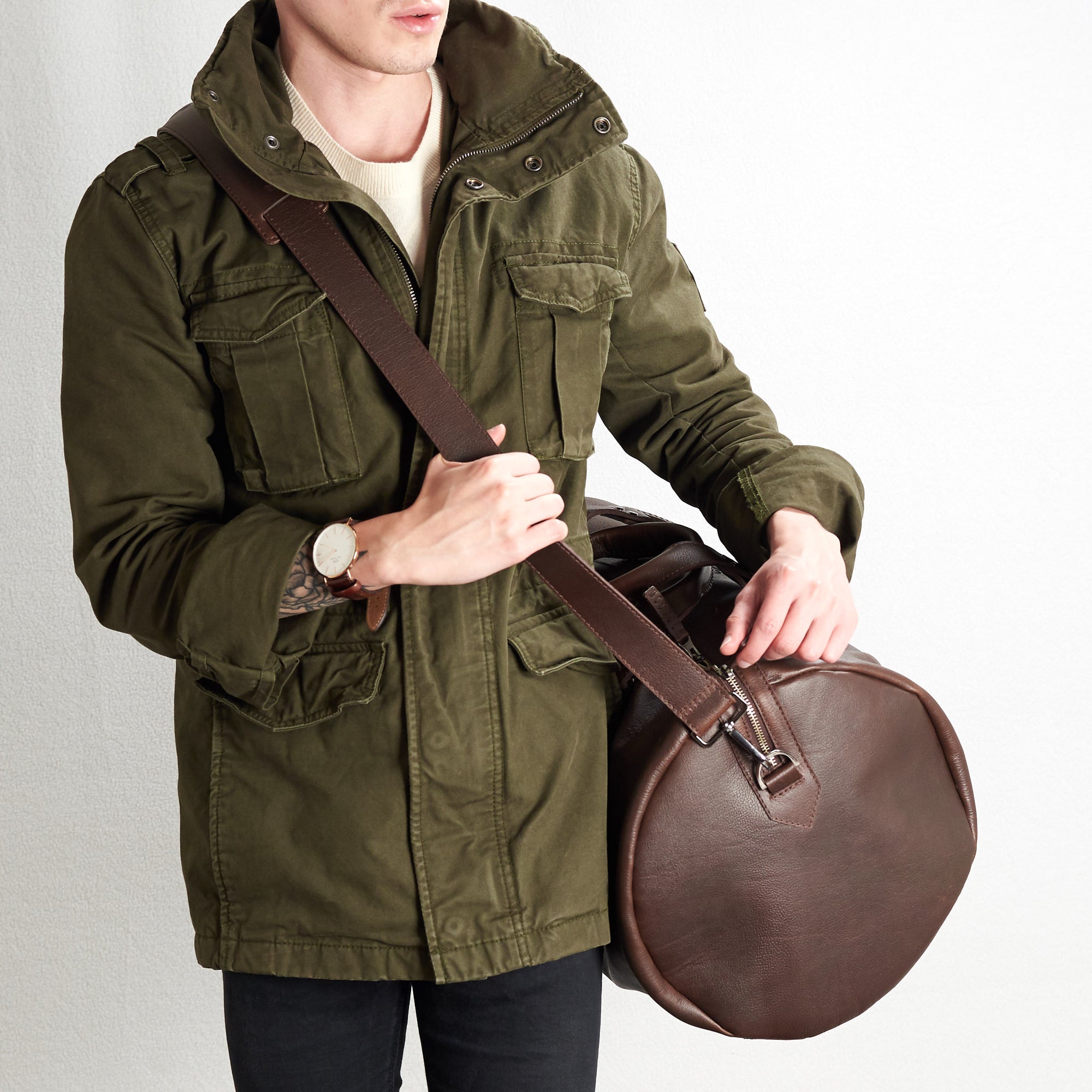 Shoulder strap with duffle bag on. Substantial dark brown duffle bag by Capra Leather.
