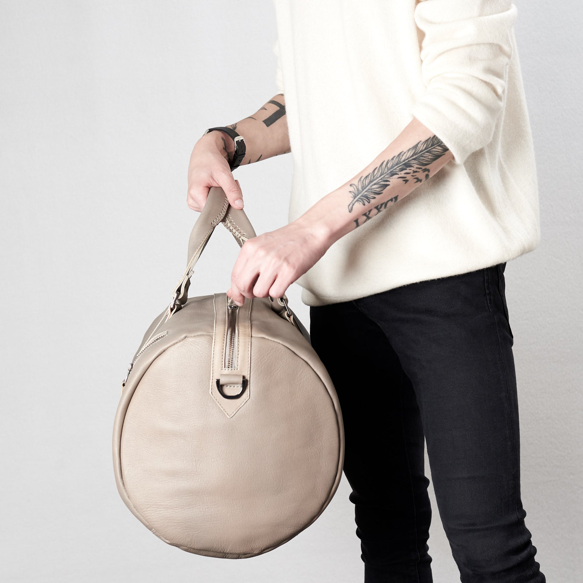 Style zipper tabs. Substantial grey duffle bag by Capra Leather. 