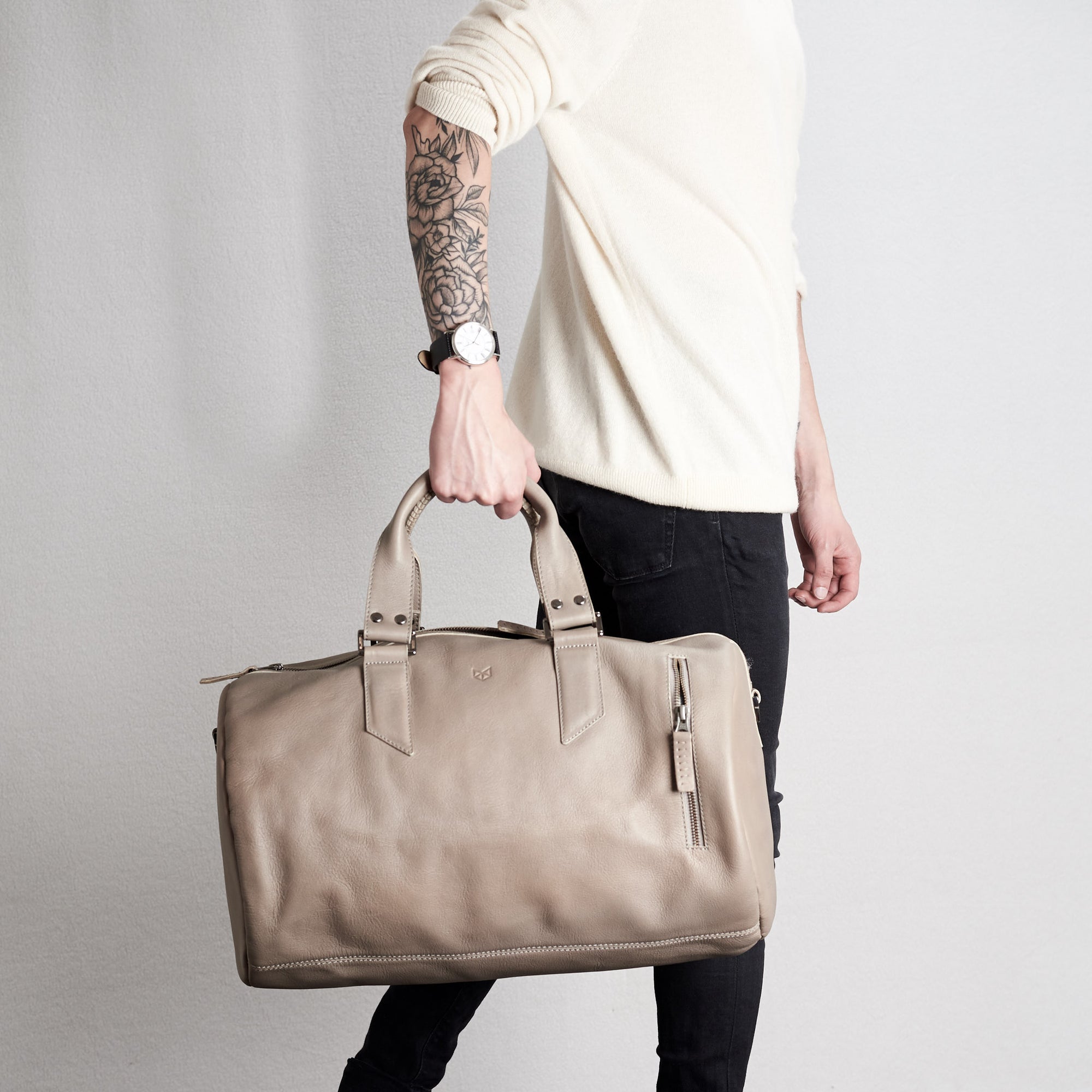 Style handles holding. Substantial grey duffle bag by Capra Leather. 