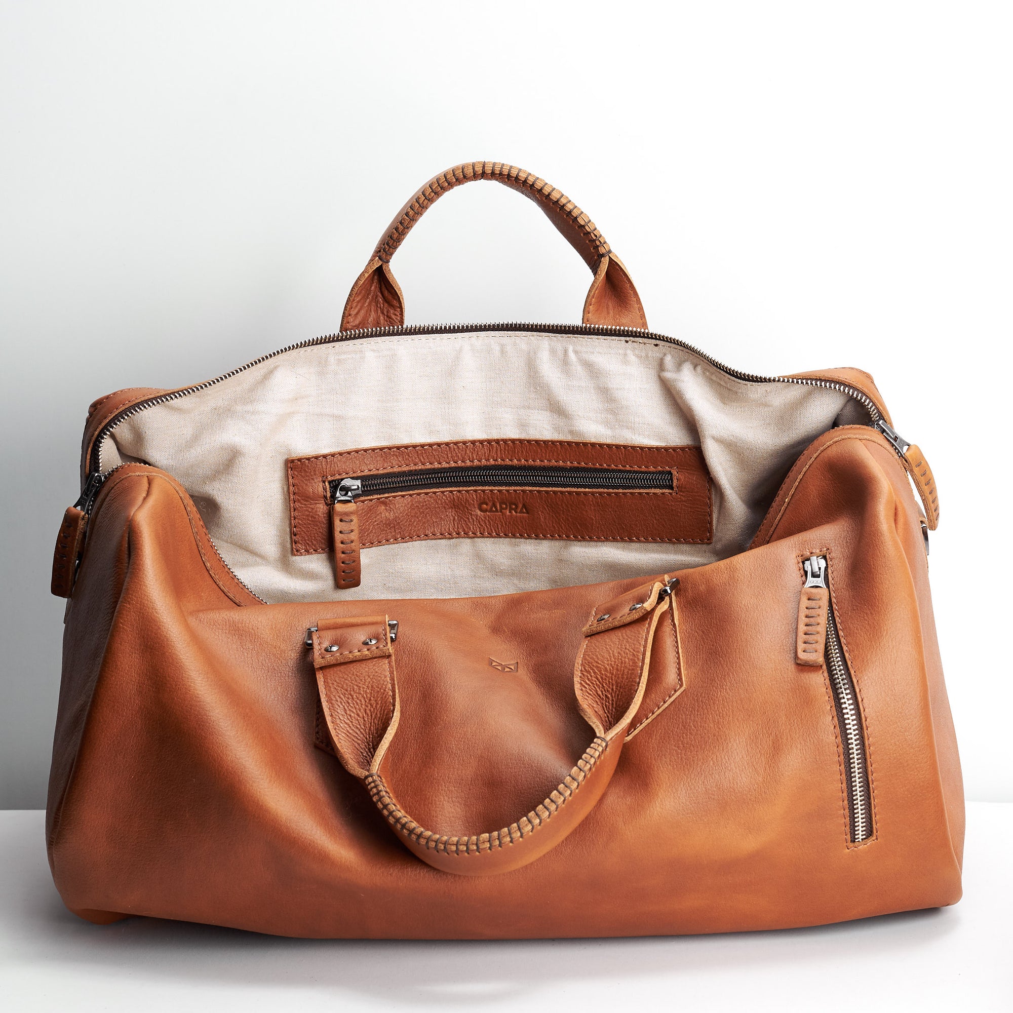 Linen interior. Handmade Tan brown leather duffle bag for men. Mens designer shoulder bag