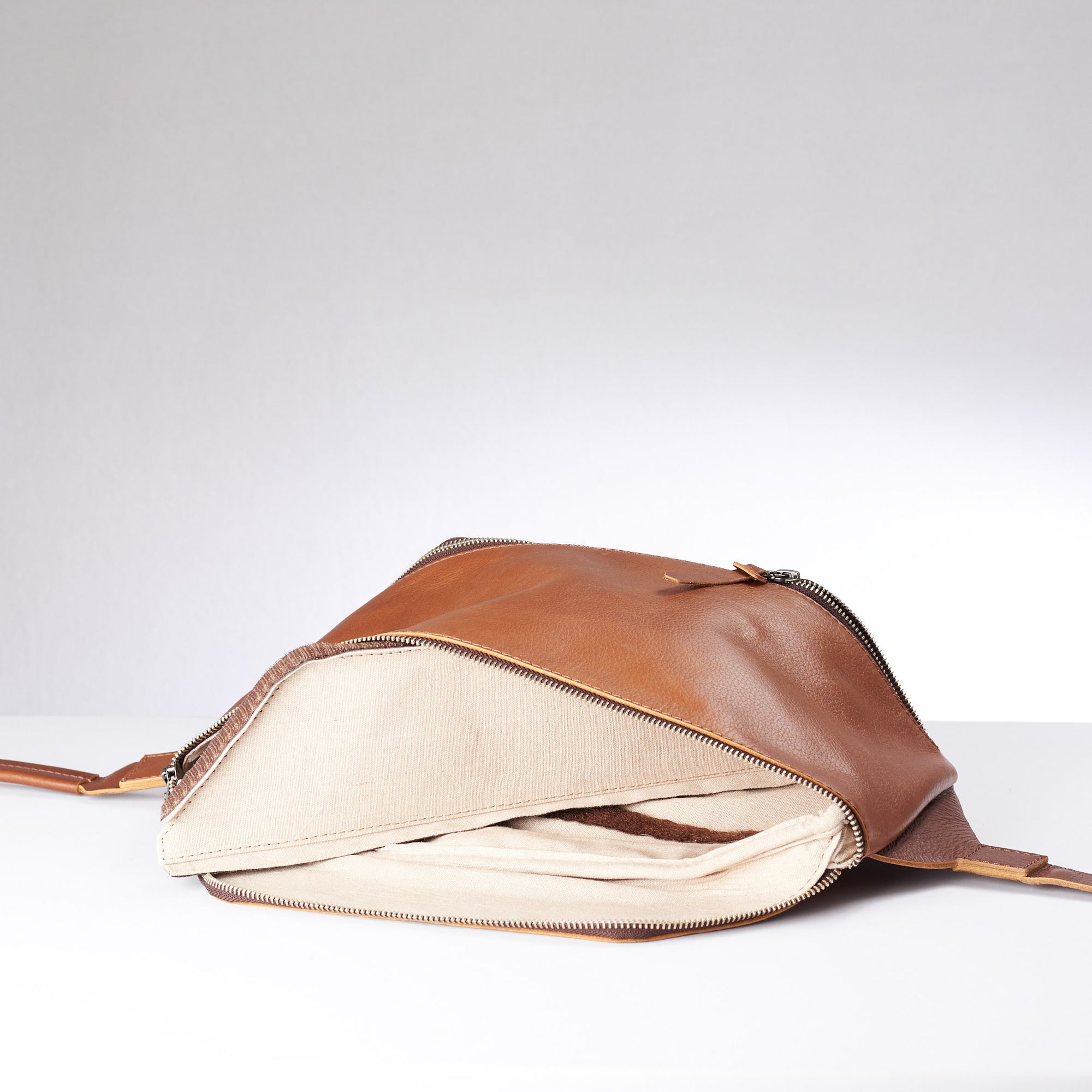 Tan Fenek sling bag backpack made by Capra Leather. Interior of shoulder bag with detachable divider.