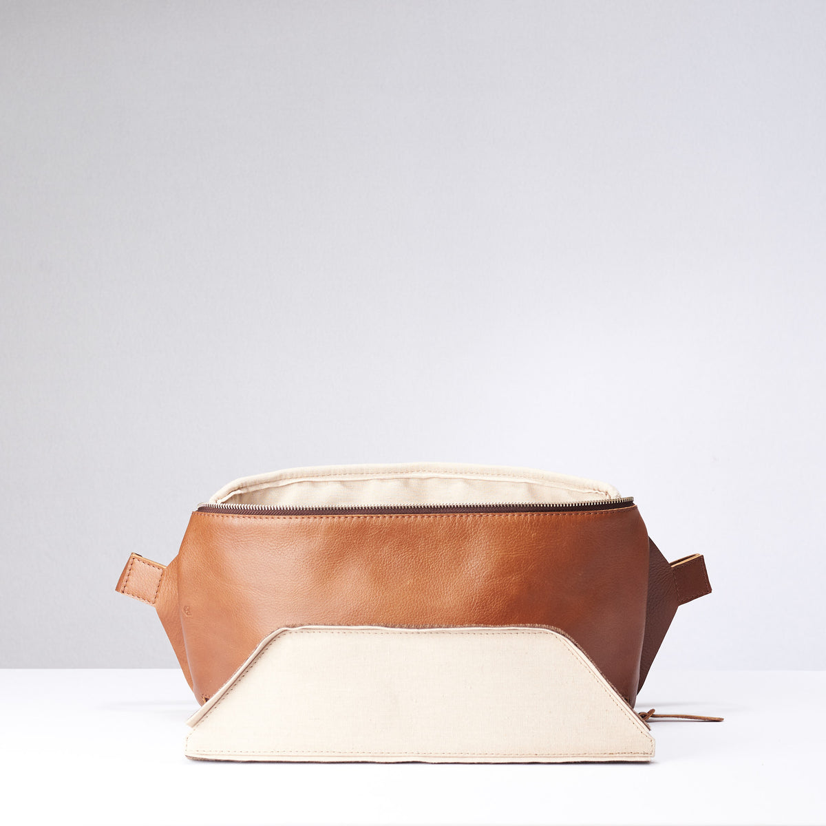 Tan Fenek sling bag backpack made by Capra Leather. Detachable divider view for street bag and bicycle backpack.