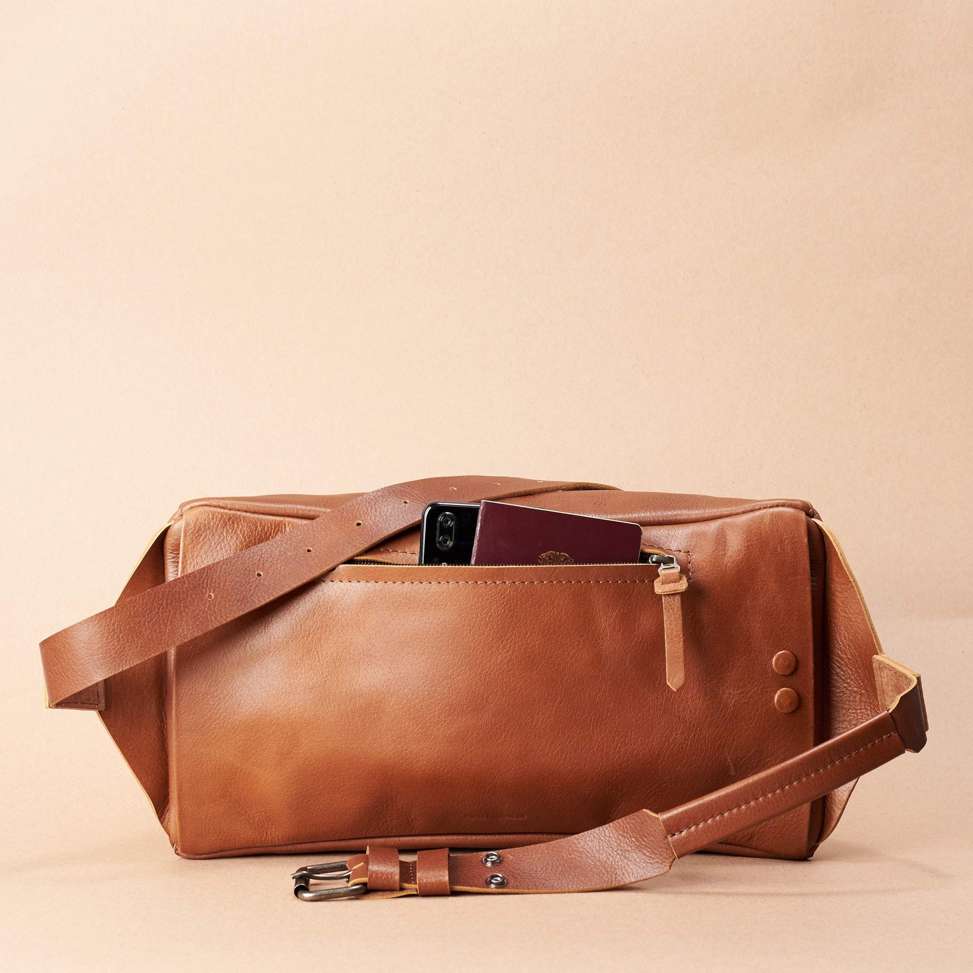 Tan Fenek sling bag backpack made by Capra Leather. Styling back pocket of small  leather crossbody for easy access.