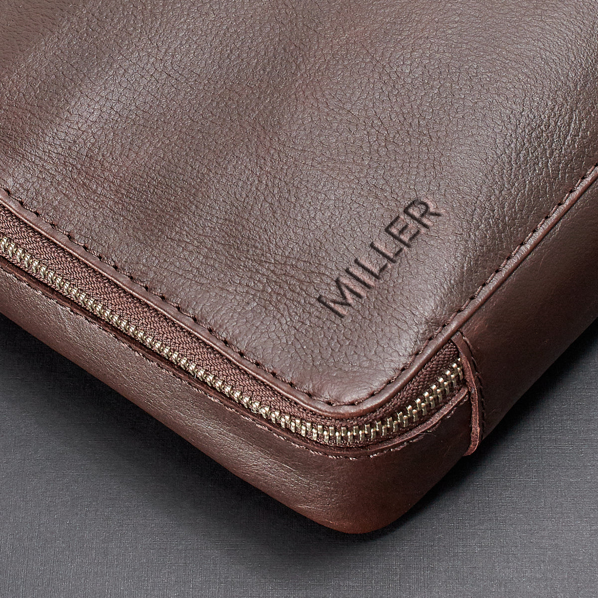Custom monogram.  Dark brown EDC laptop bag by Capra Leather