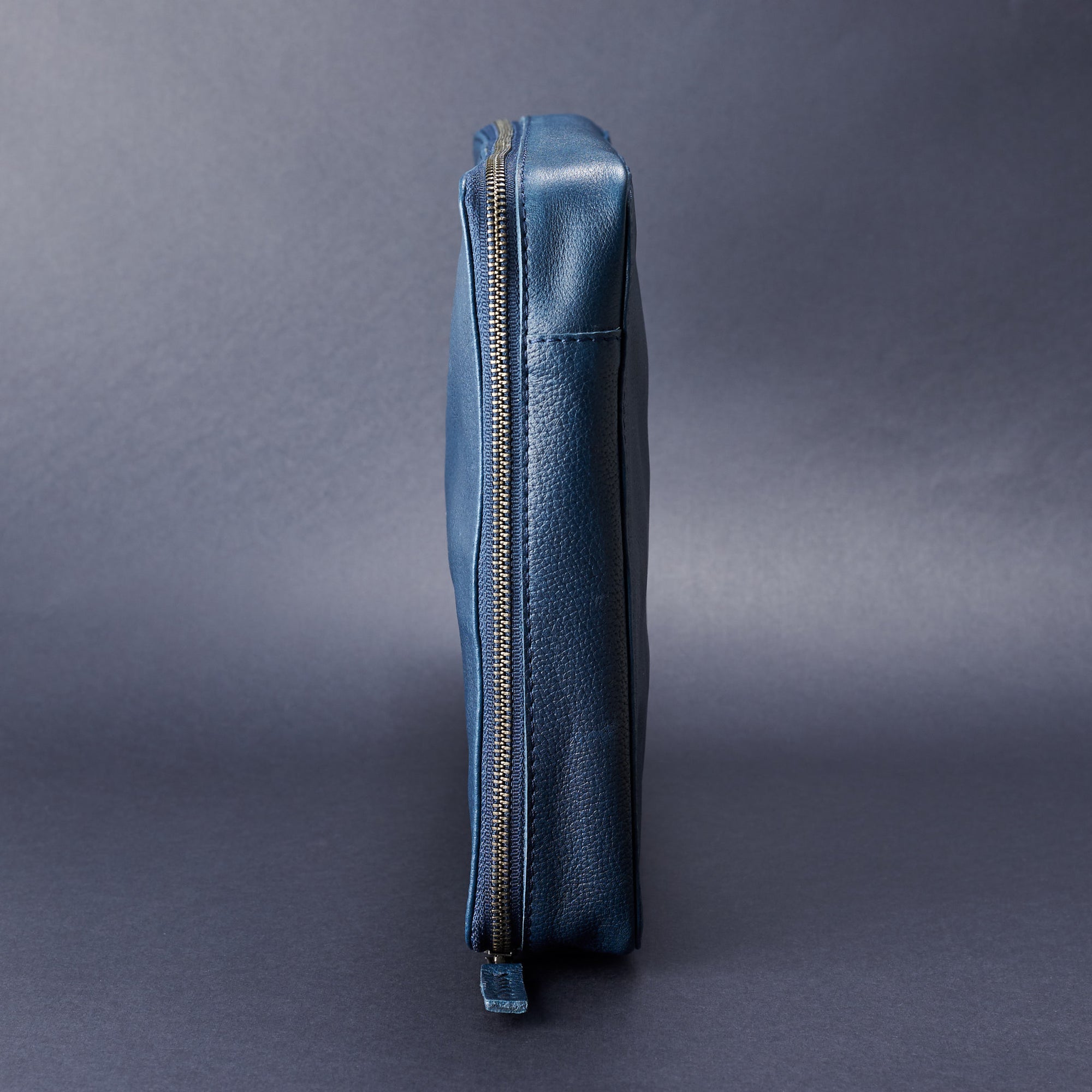 Side view. Navy blue tech organizer pouch by Capra Leather