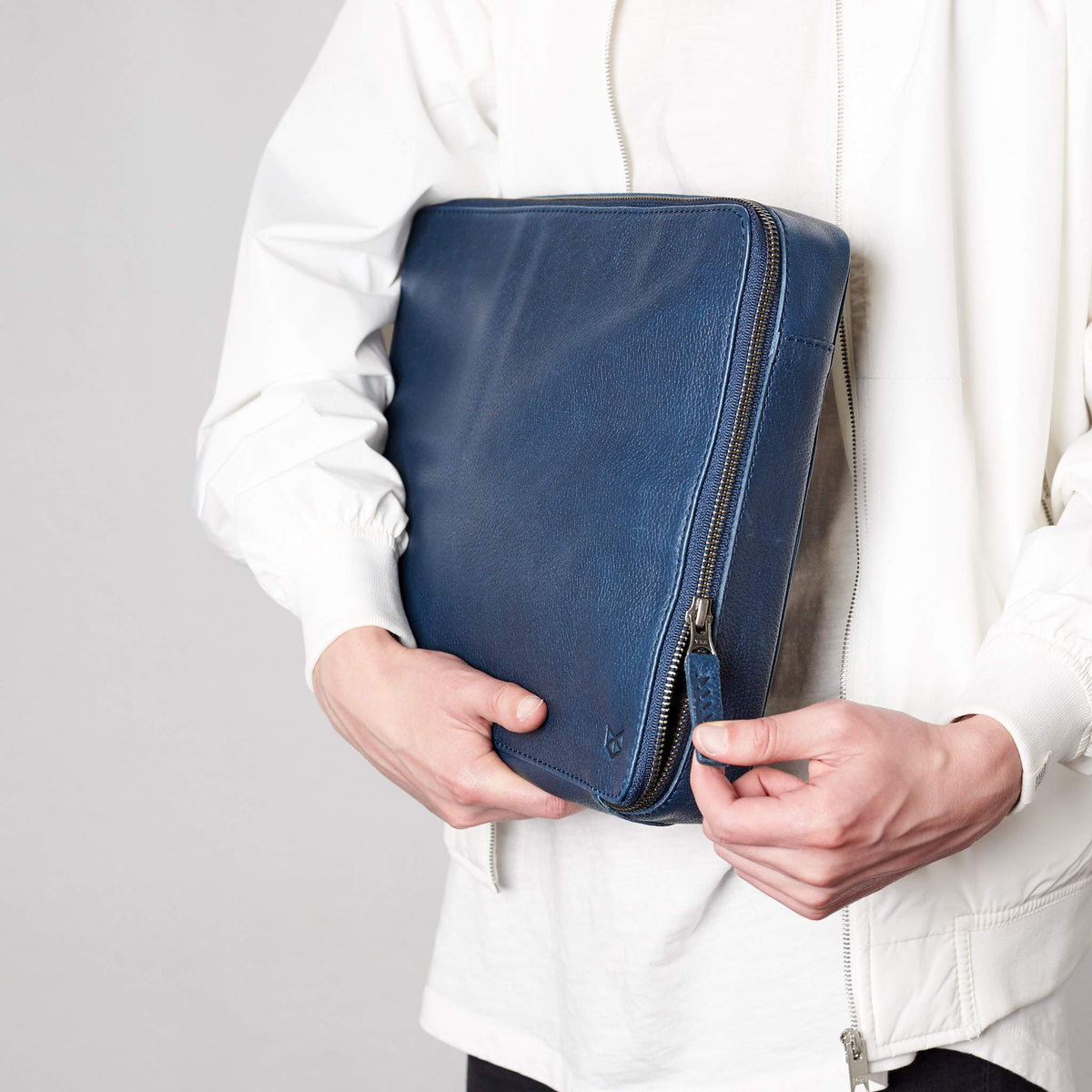 Hand stitched pull tabs. Navy blue electronic organizer by Capra Leather. Fits MacBook Pro 16 inch