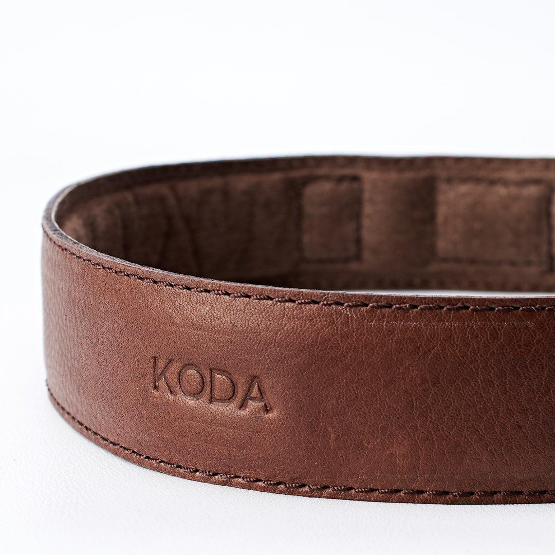 Custom engraving detail. Handmade minimal dark brown leather padded dog collar by Capra Leather.
