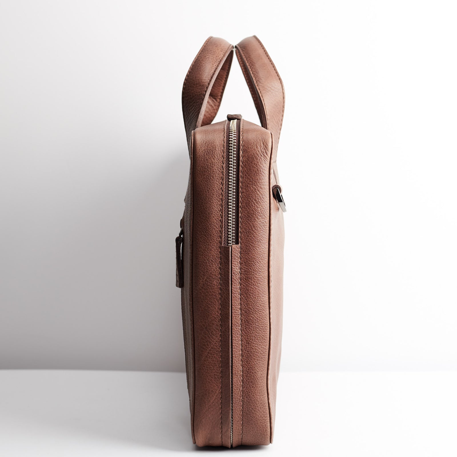 Slim profile. Brown leather briefcase for men. Office style mens workbag