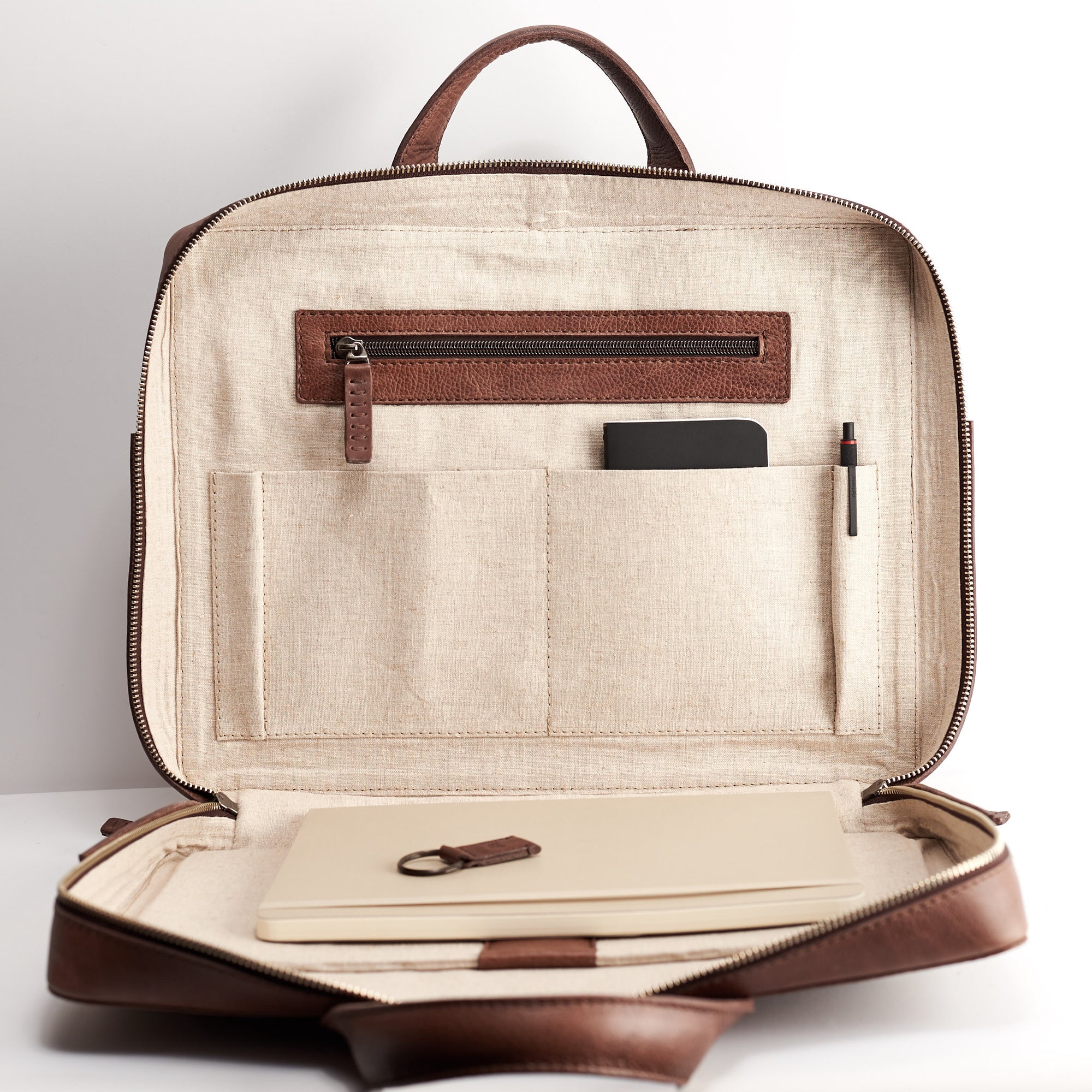 Interior pocket detail. Brown leather briefcase for men. Minimalist designer workbag 