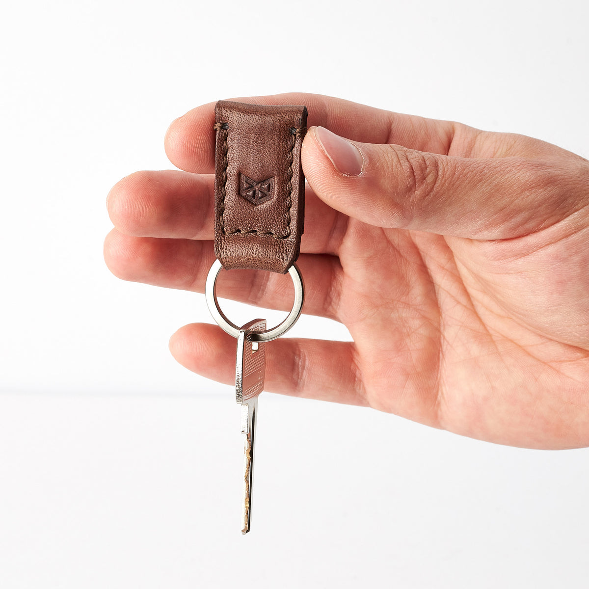 Style photo. Brown leather magnetic keychain for mens gifts