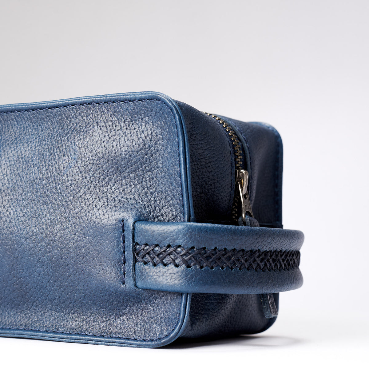 Handler detail. Ocean blue leather toiletry, shaving bag with hand stitched handle. Groomsmen gifts. Leather good crafted by Capra Leather 