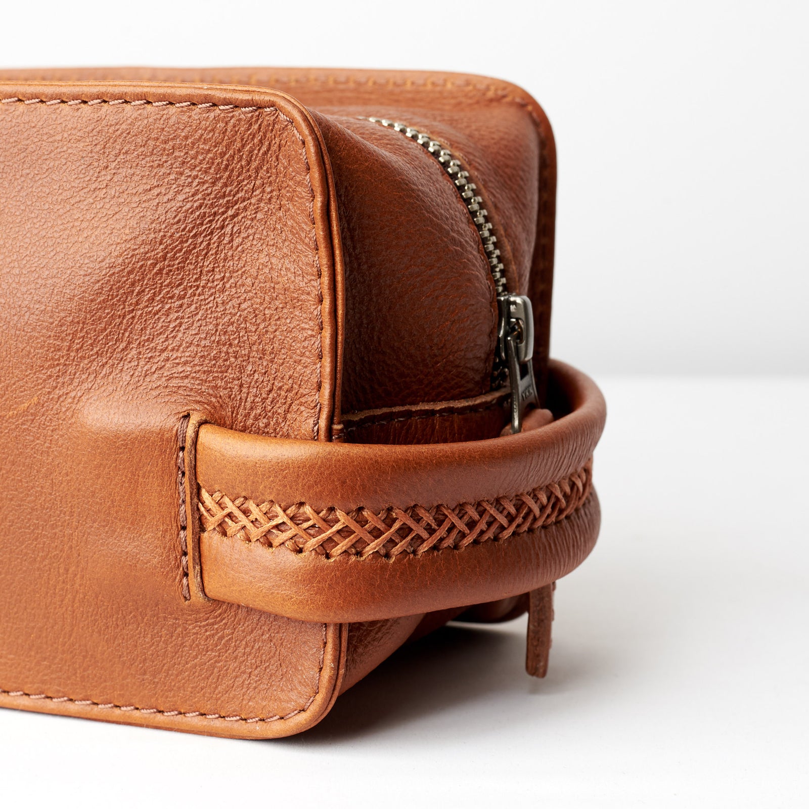 Handler detail. Tan leather toiletry, shaving bag with hand stitched handle. Groomsmen gifts. Leather good crafted by Capra Leather 