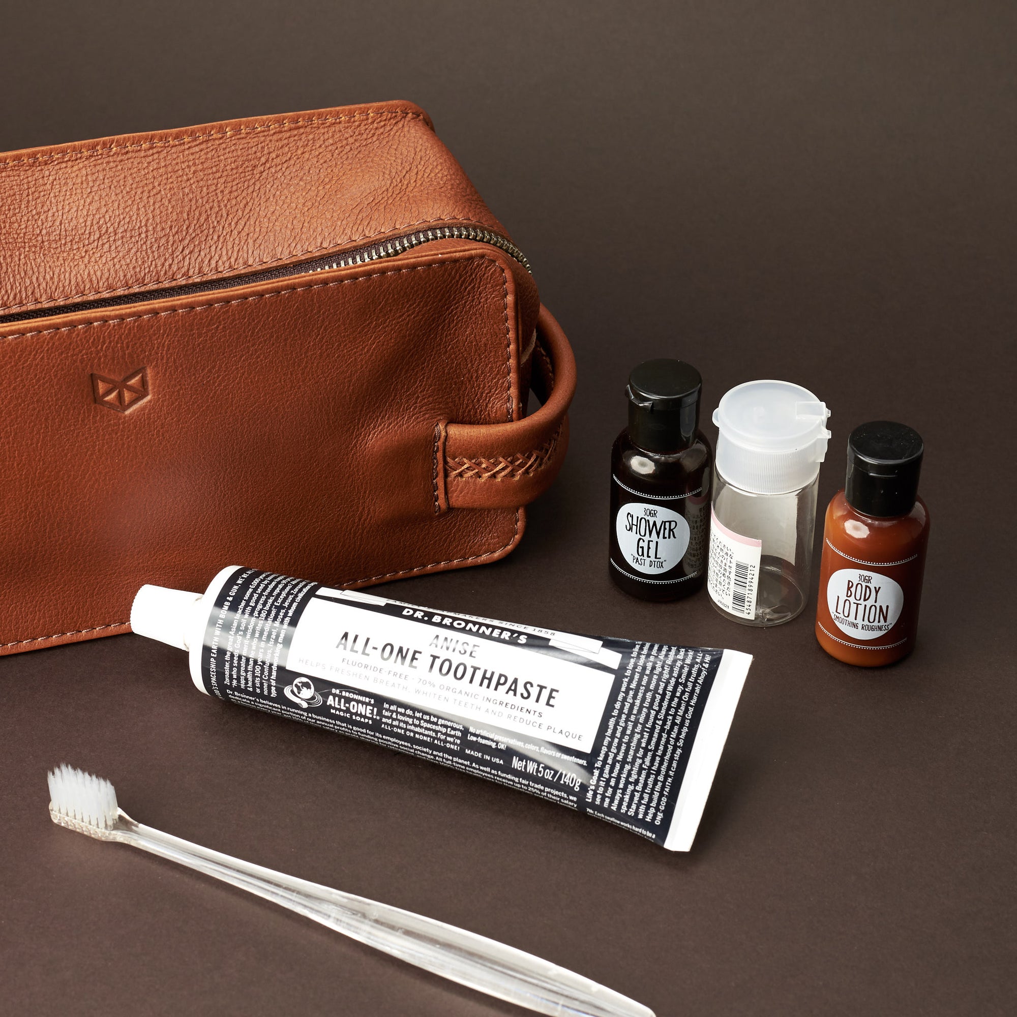 Styling. Tan leather toiletry, shaving bag with hand stitched handle. Groomsmen gifts. Leather good crafted by Capra Leather 